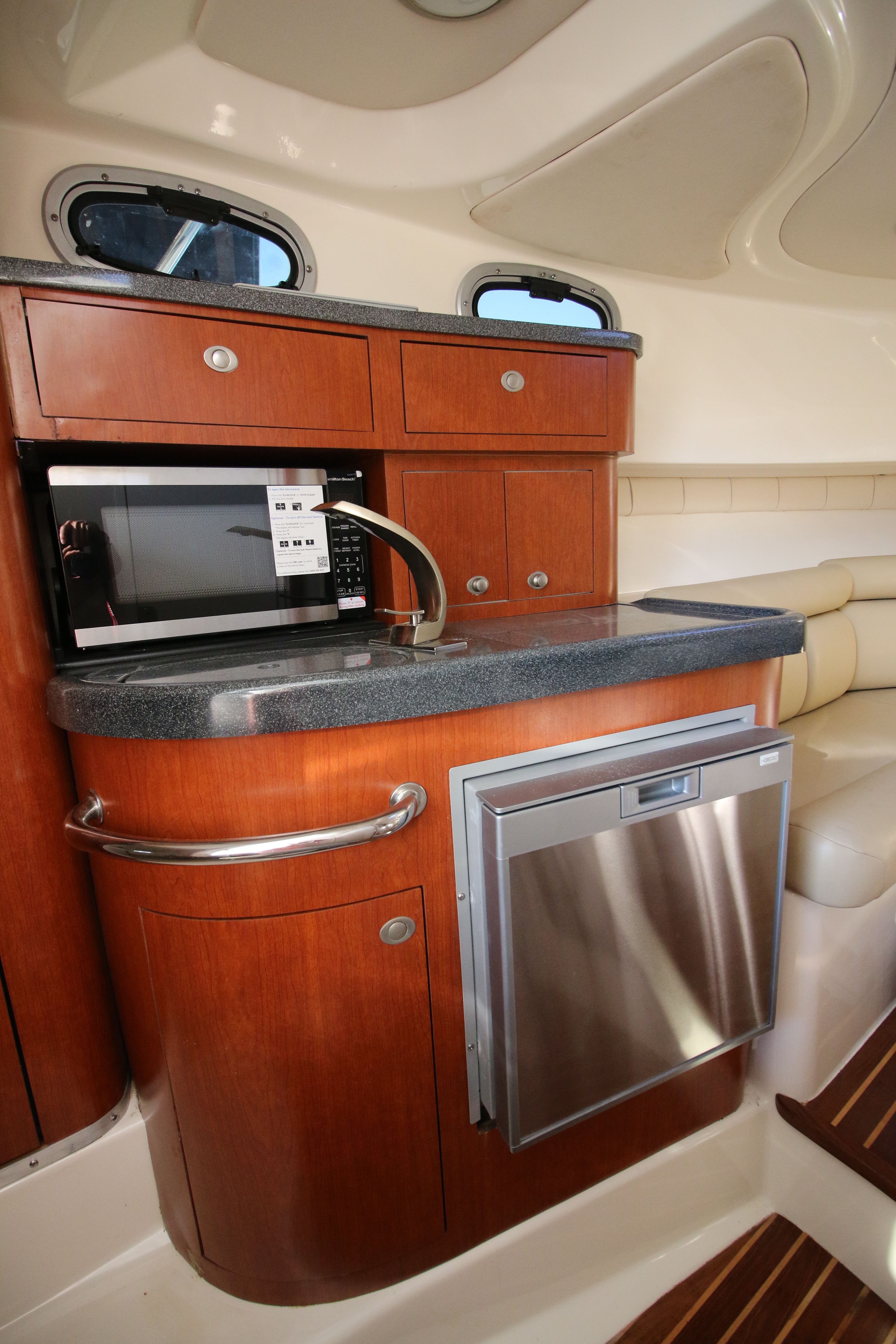 Galley of the 2006 Boston Whaler 305 Conquest with microwave and refrigerator.
