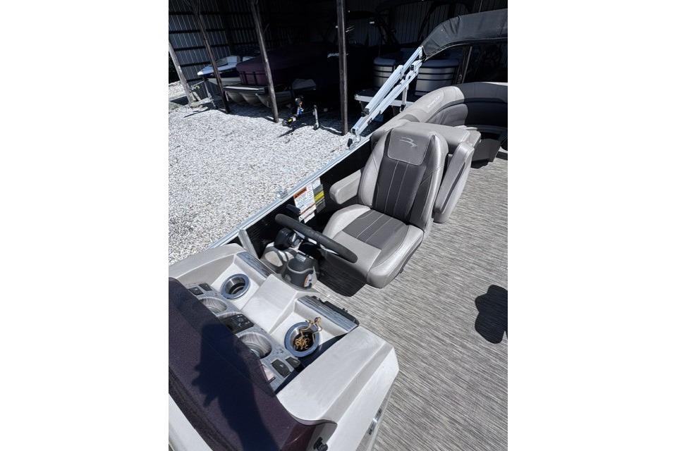 2021 Bennington 23 SSRX boat interior with steering console and seating.