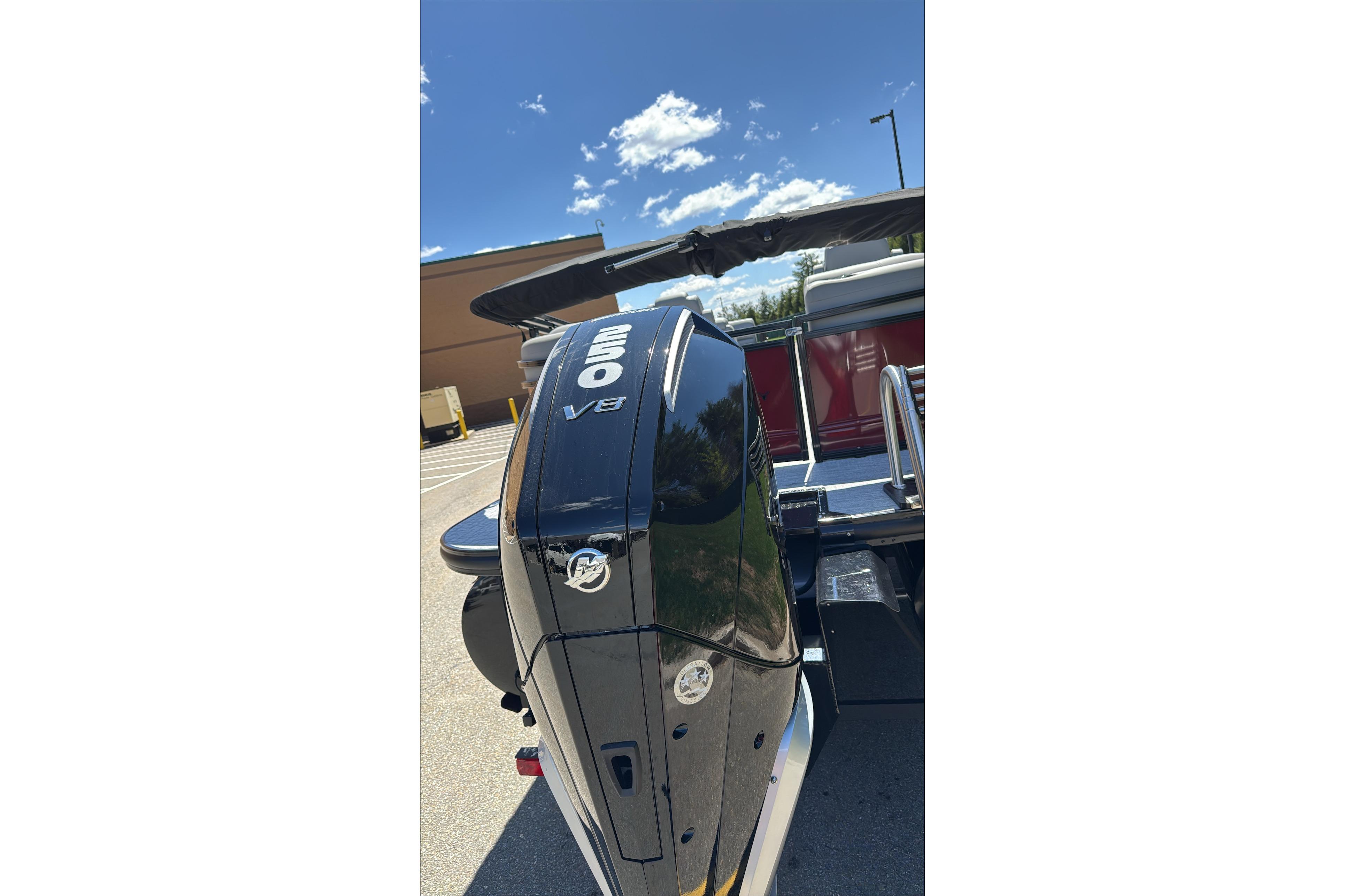 2026 Regency 230 DL boat with powerful V8 engine under clear blue sky.