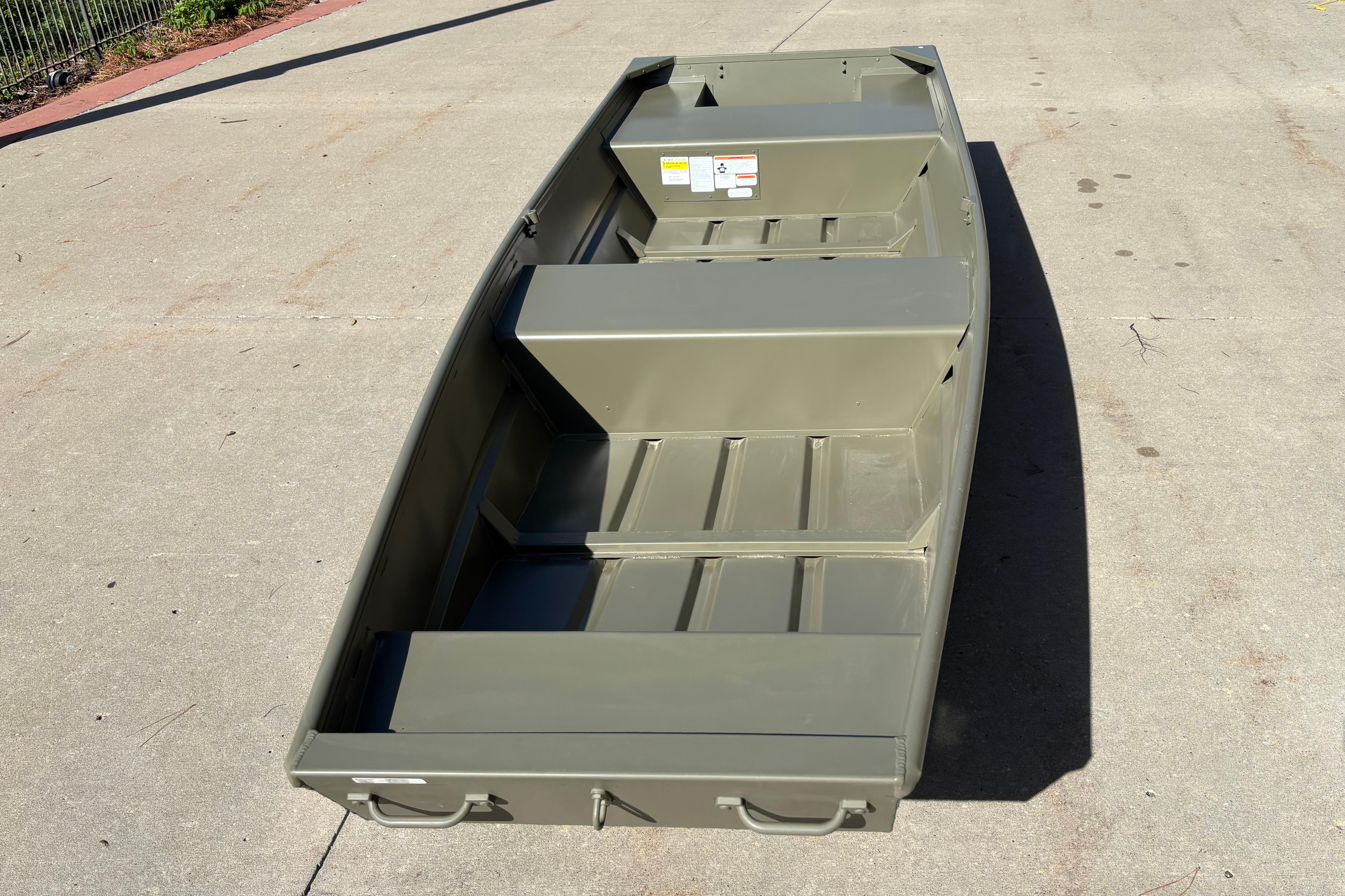 2026 Tracker Grizzly 14 Jon boat on concrete surface, showcasing interior layout.