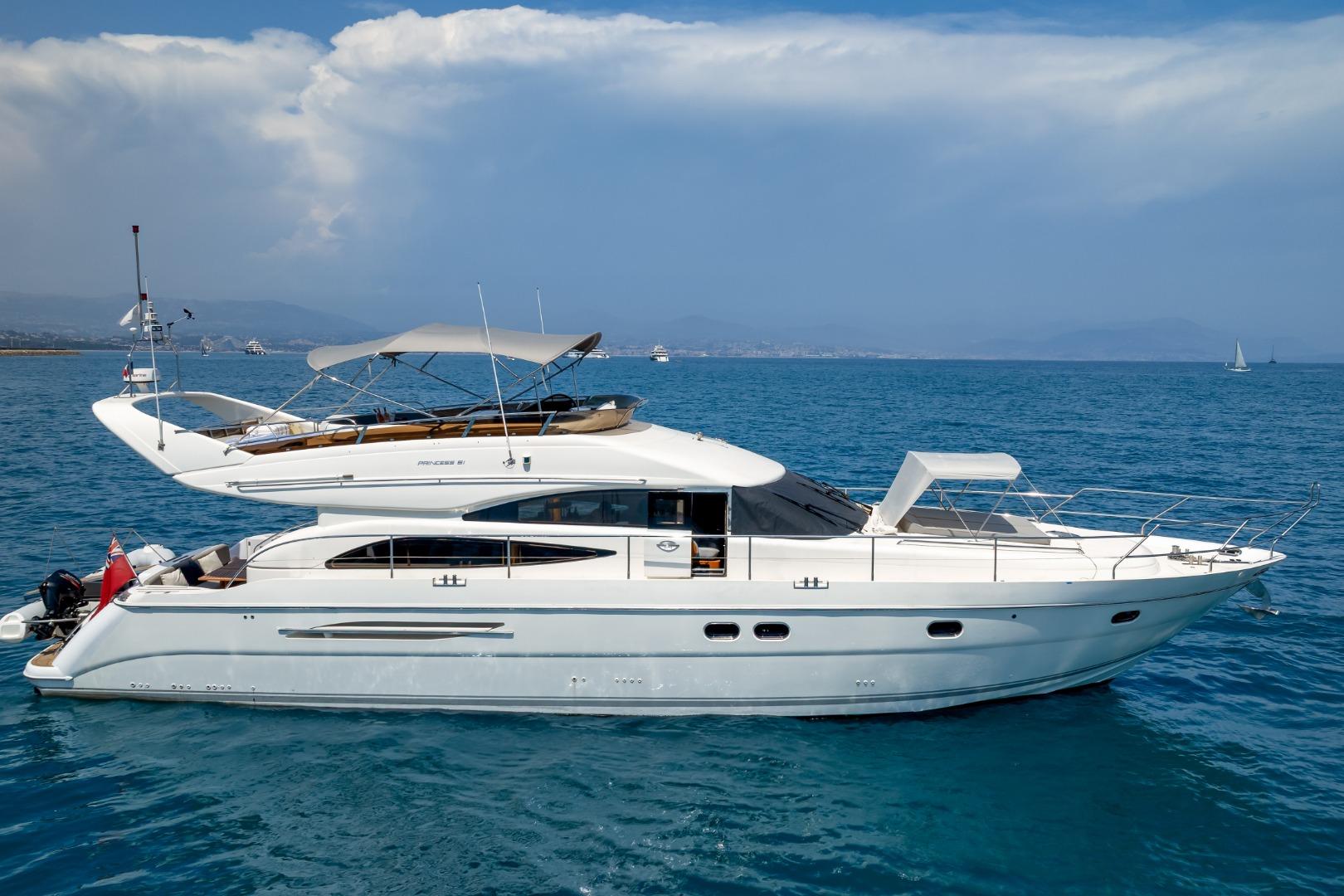 Luxury Princess 61 yacht from 2001 cruising on clear blue waters.