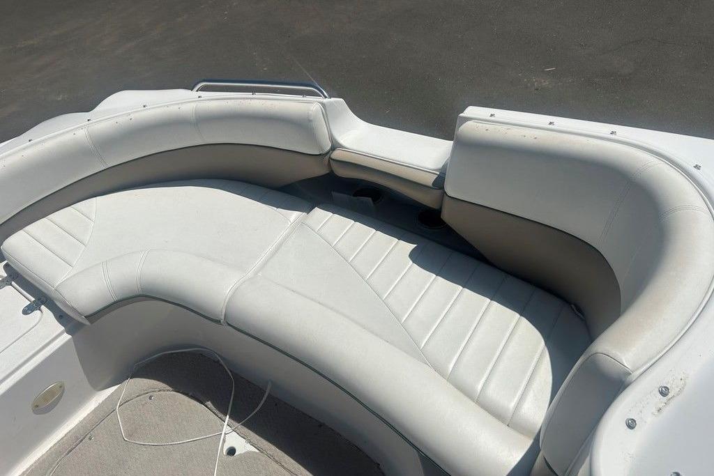 2006 Four Winns 244 Funship boat interior with white cushioned seating.