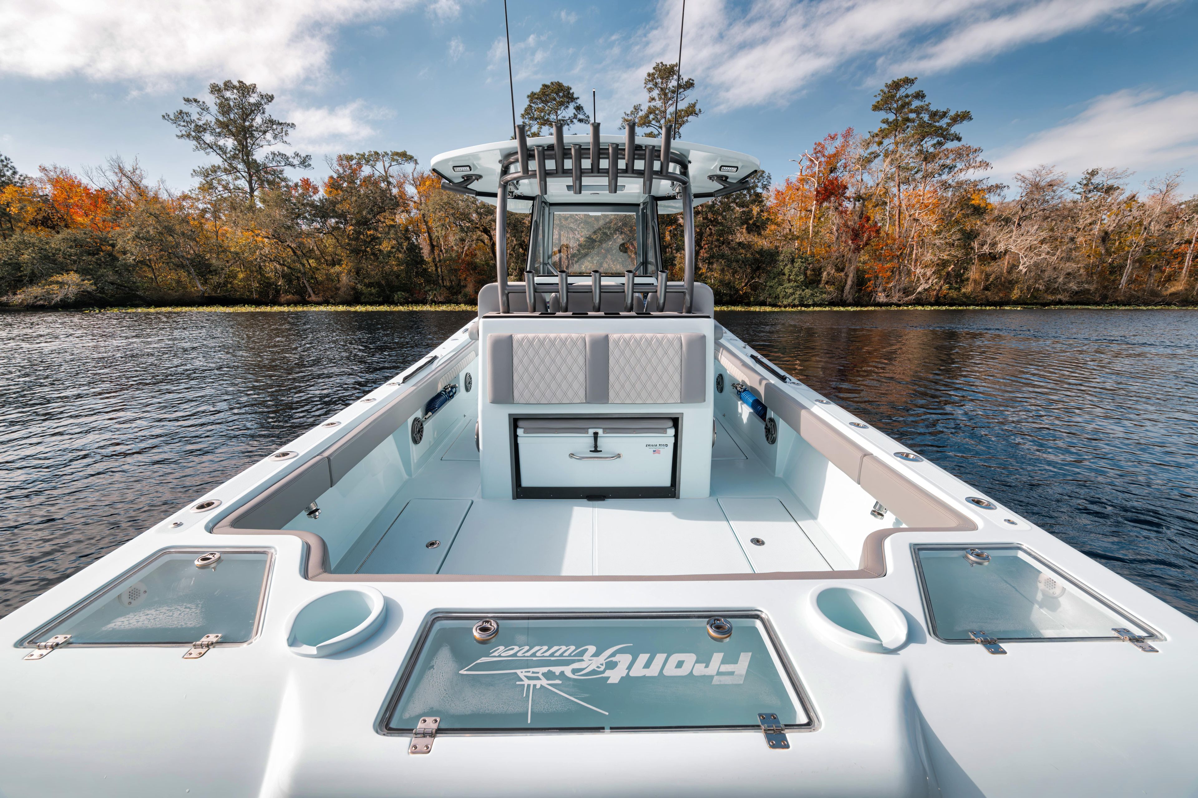 2026 Front Runner 36' Center Console boat on a scenic lake with autumn trees.