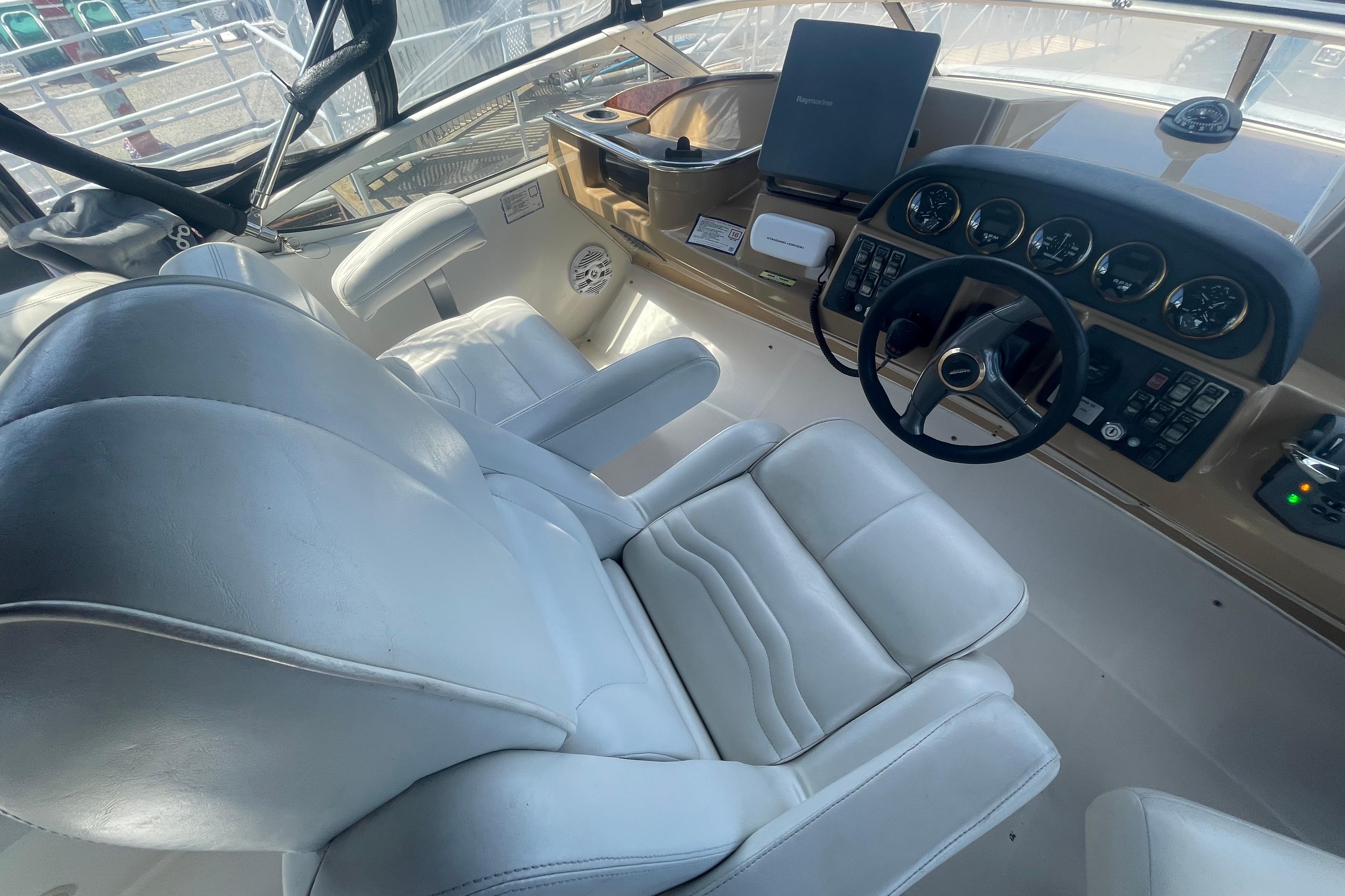 Interior of a 2002 Carver 410 Sport Sedan with white leather seating and control panel.