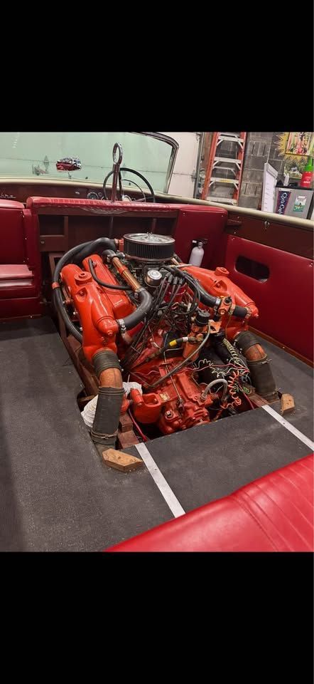 1965 Century Sabre motorboat with exposed engine compartment.