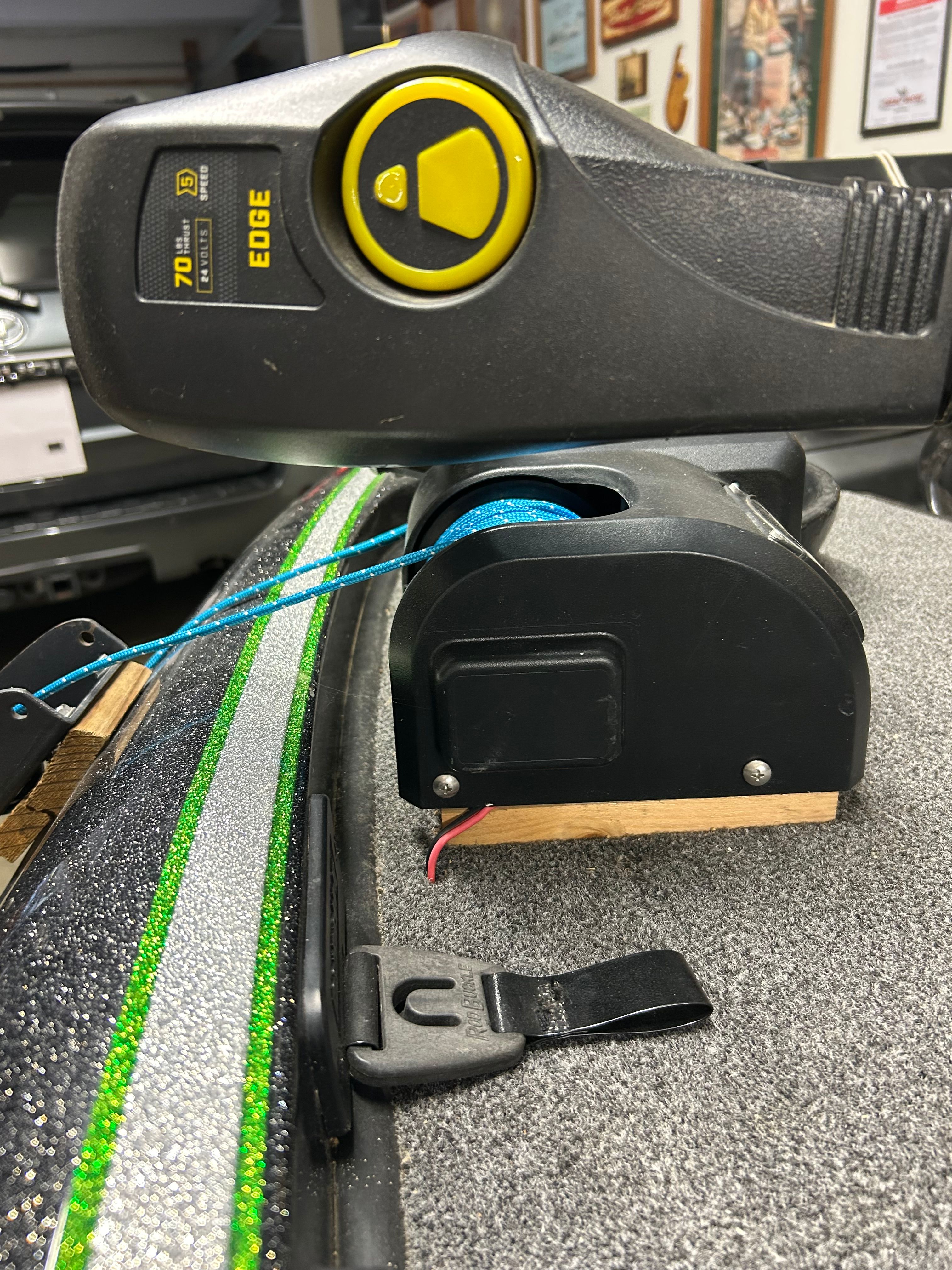 Close-up of a boat deck with a fishing reel and control unit.