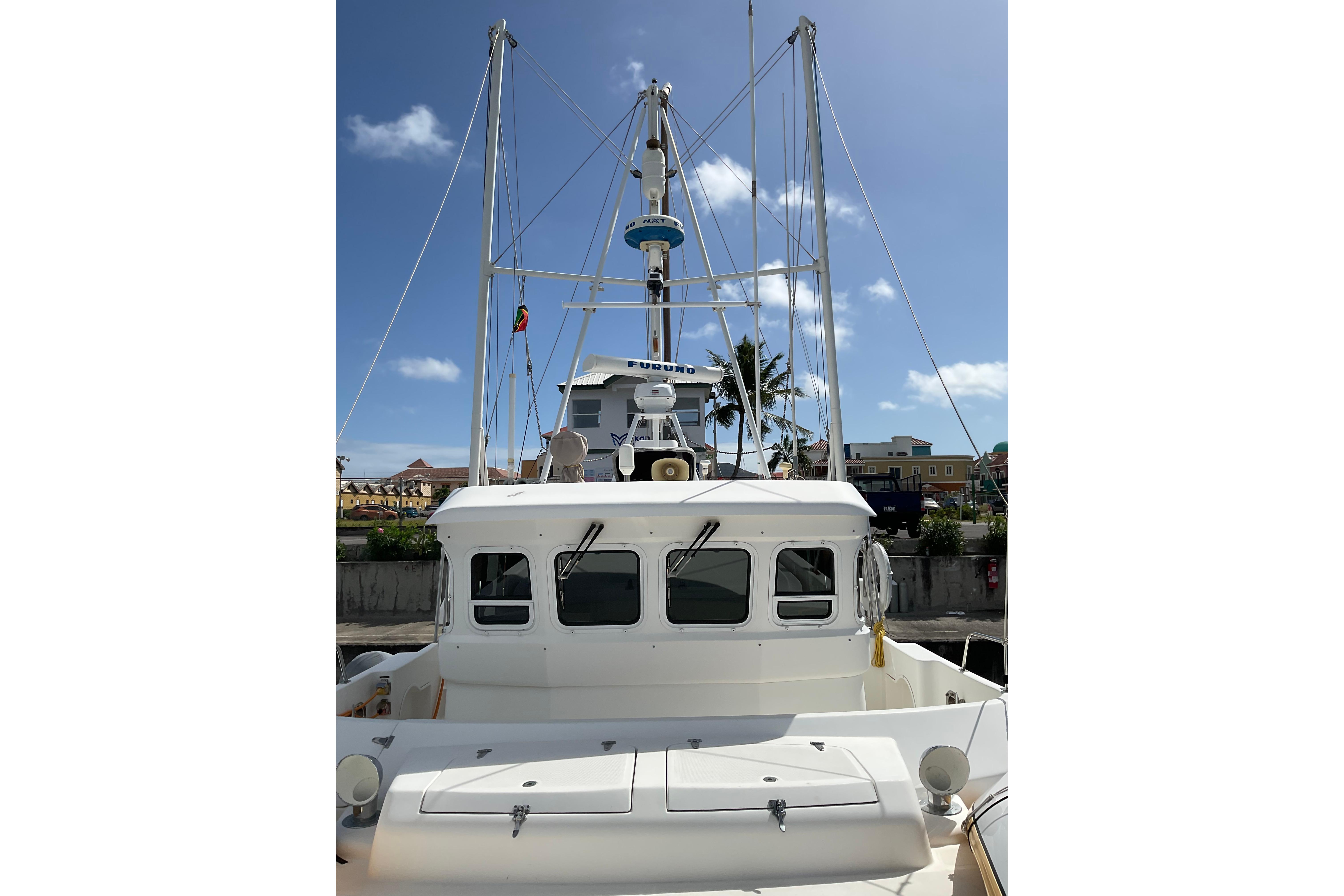 Nordhavn 40 yacht, 2000 model, docked under clear blue sky.