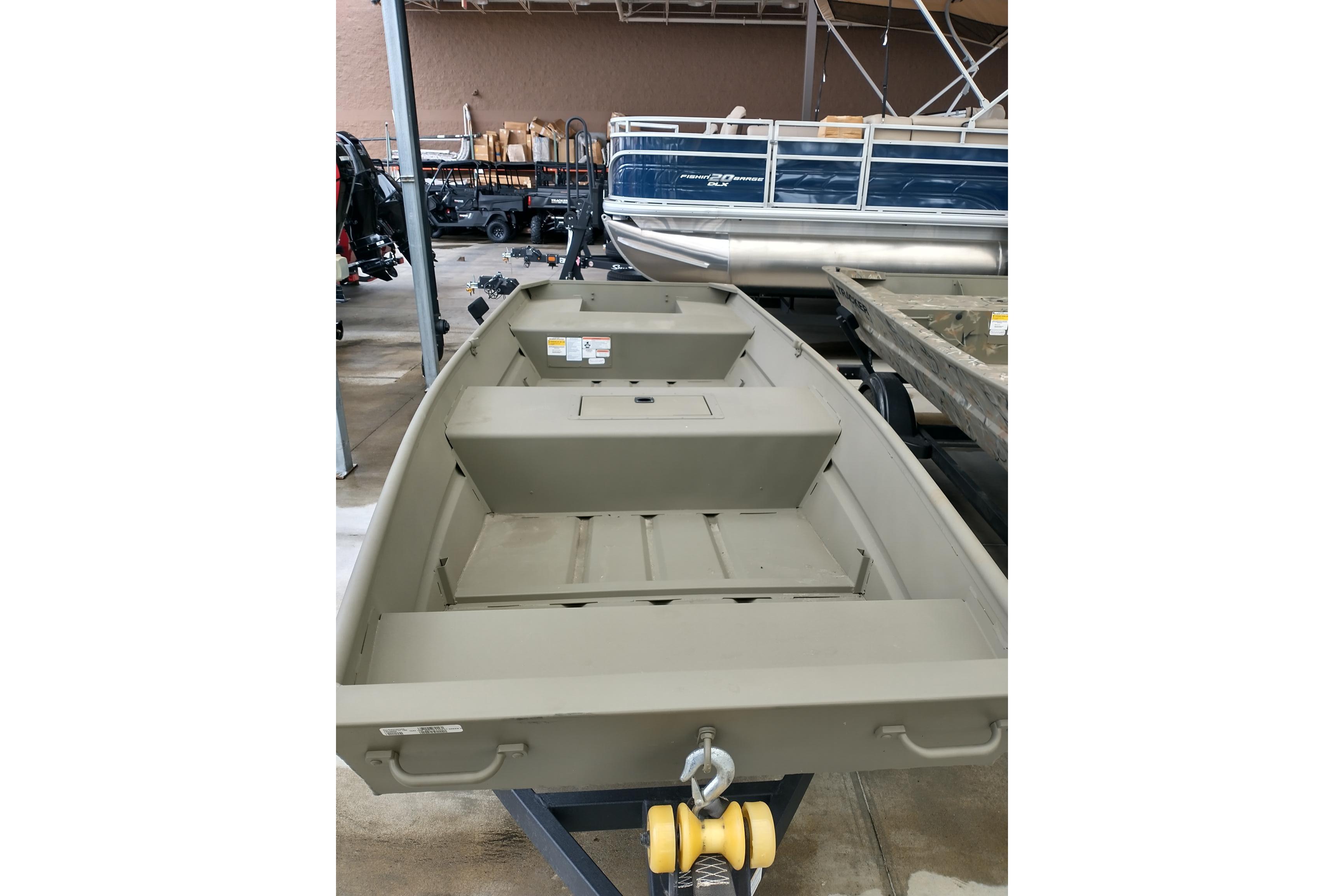2026 Tracker Grizzly 15 Jon boat displayed in a showroom, showcasing its interior layout.