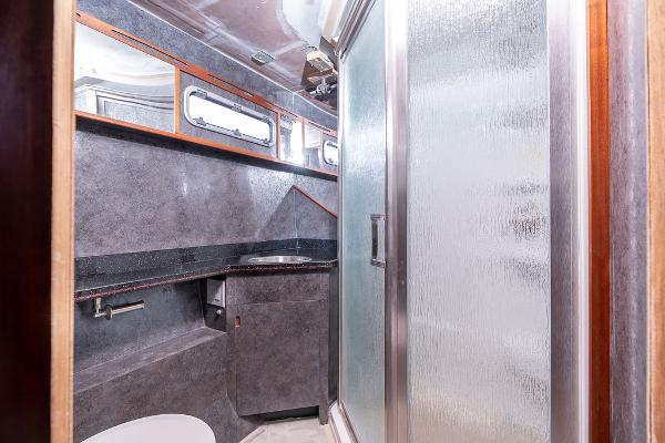 Modern bathroom interior on 2025 Catamaran Bloomfield 86 Motorsailor, featuring sleek design and shower.