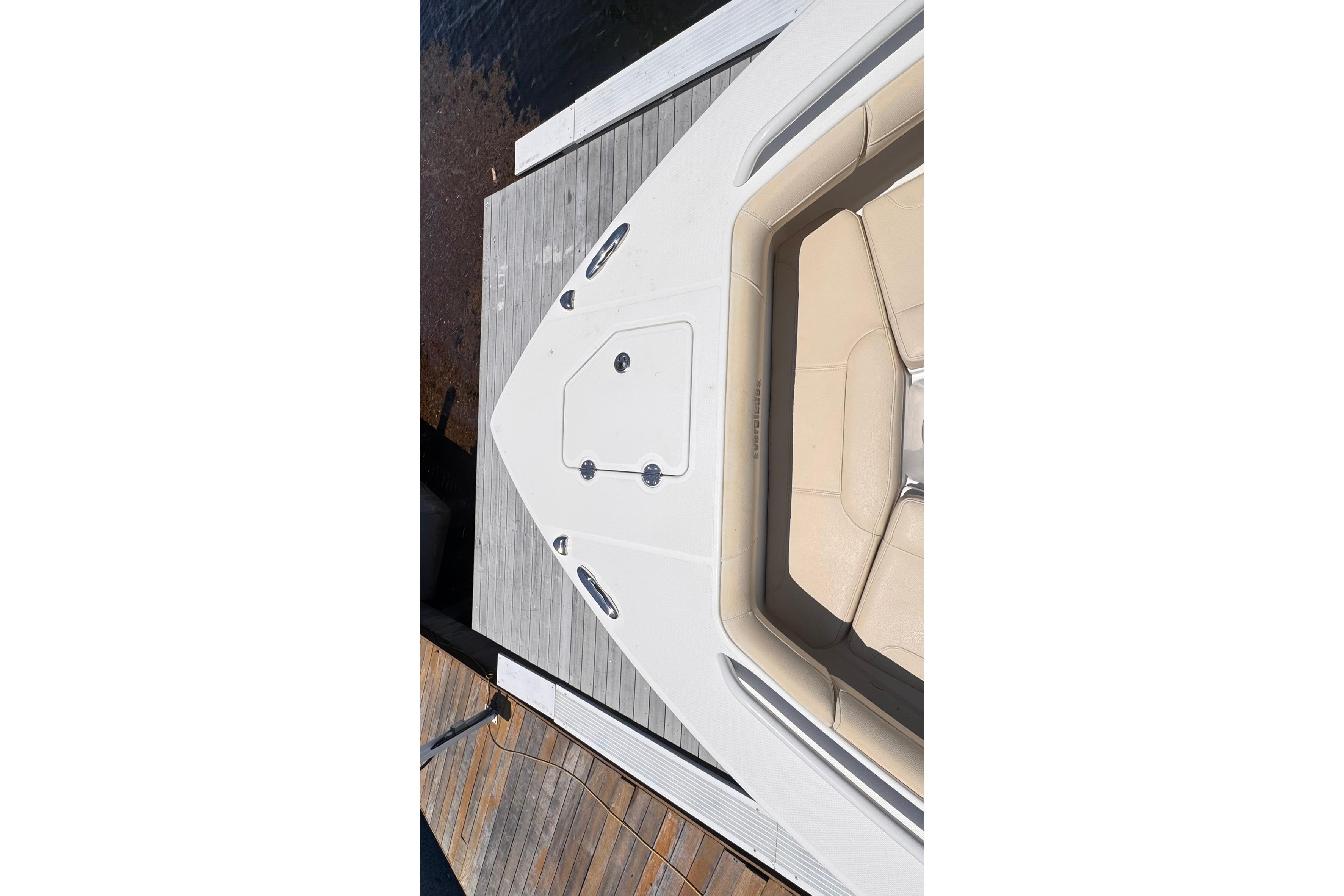 Overhead view of 2018 Everglades 253 Center Console boat docked by wooden pier.
