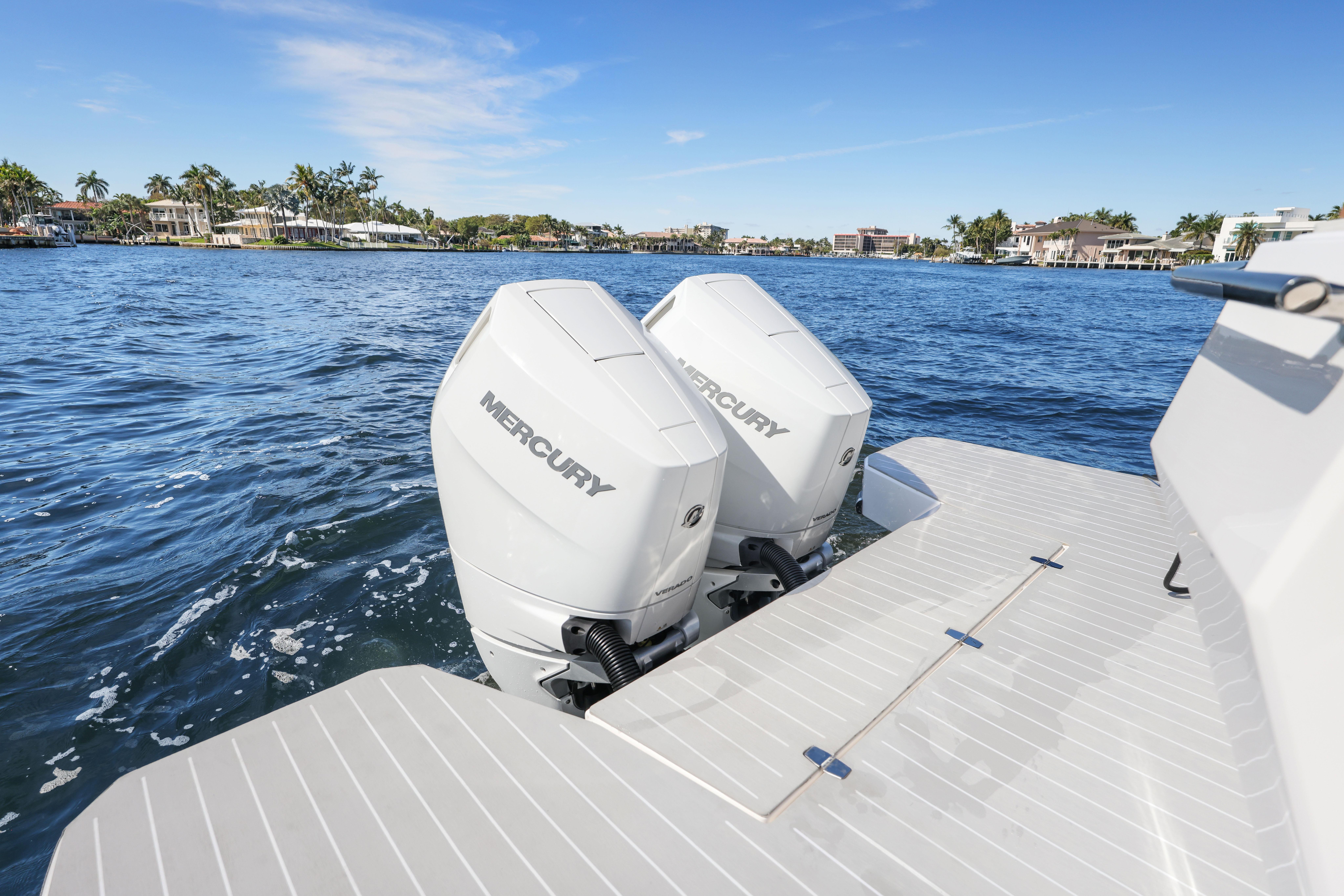 2025 Valiatt 380 Bowrider with dual Mercury outboard engines on a sunny waterfront.