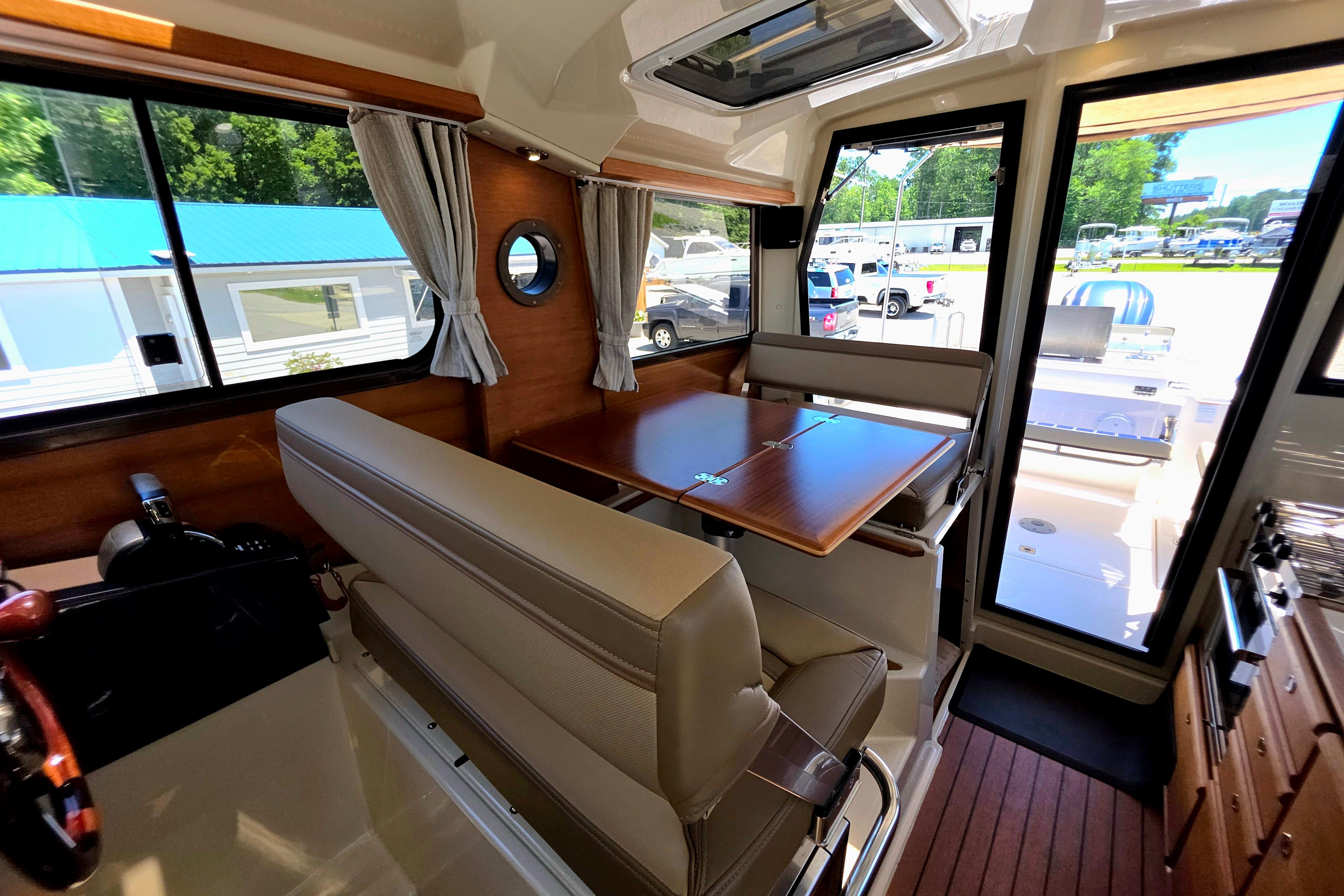 Interior of 2021 Ranger Tug R27 boat with seating and dining area.