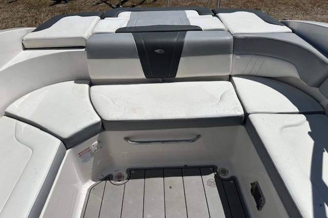 2023 Chaparral 23 SSi boat interior with cushioned seating and sleek design.