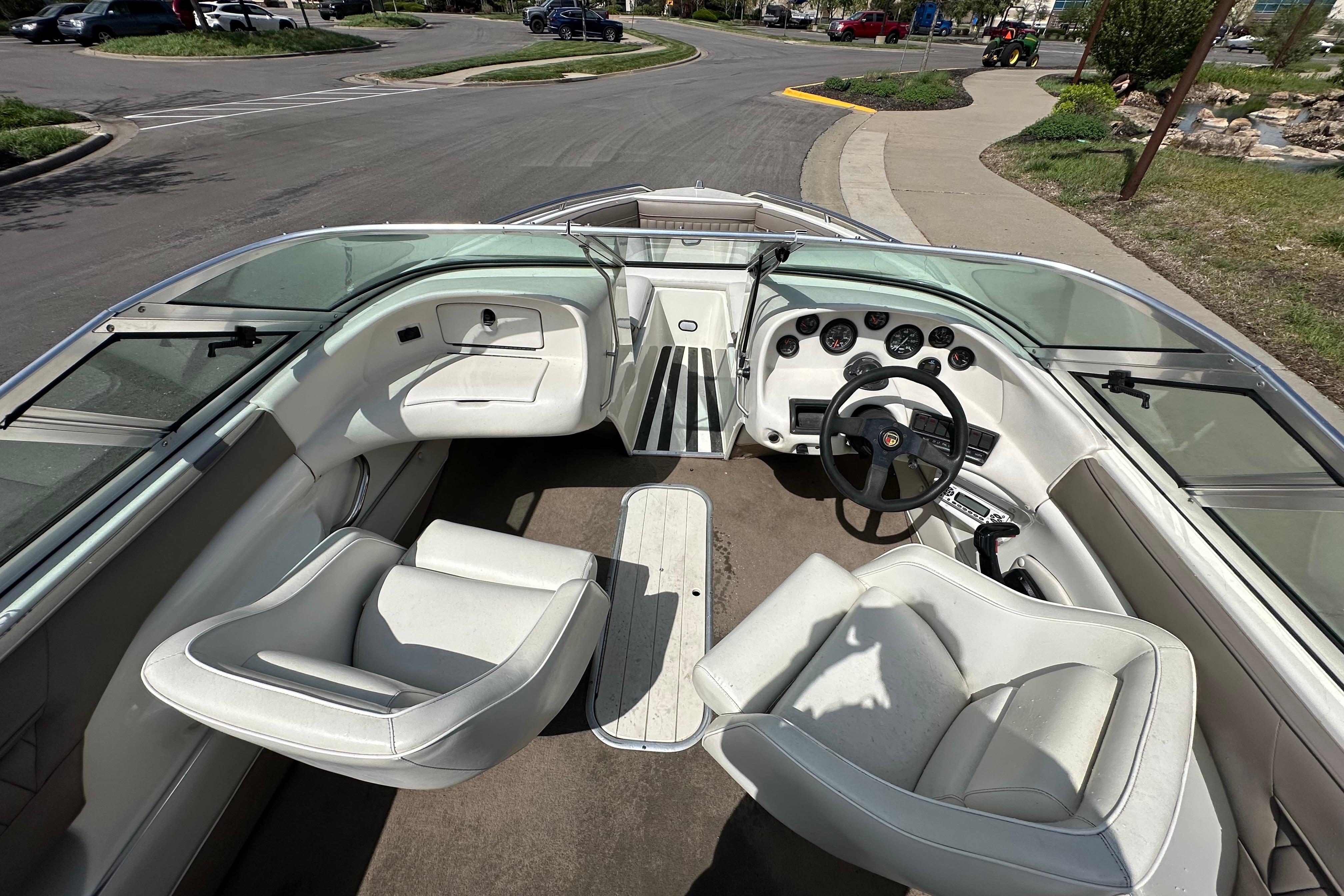 Interior of a 1995 Mariah 180 Shabah boat with white seating and dashboard.