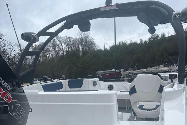 2024 Tahoe 1950 boat interior with seating and steering wheel, overcast sky background.