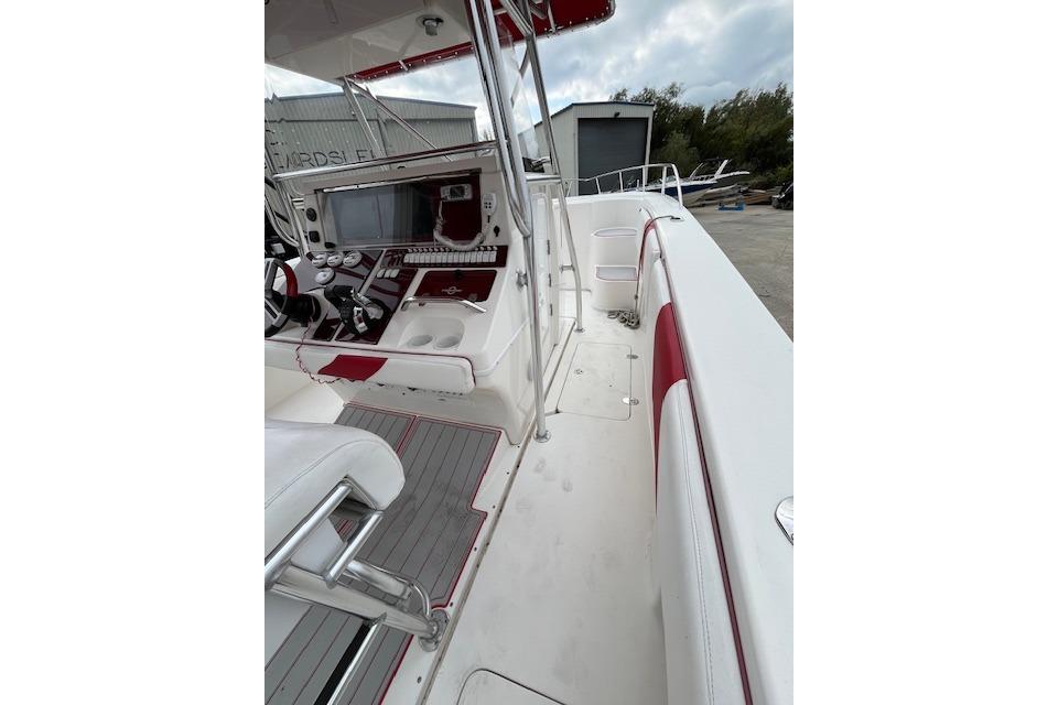 2001 Fountain 38 Center Console boat interior with red and white seating and control panel.