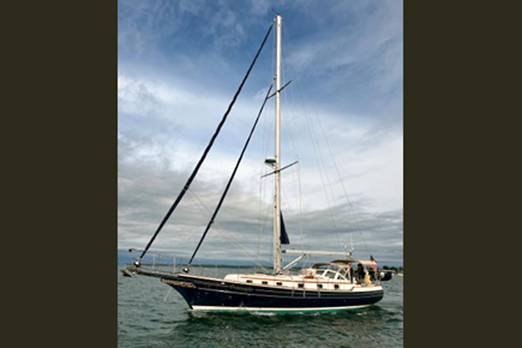 2008 Gozzard 41B sailboat on open water under a cloudy sky.
