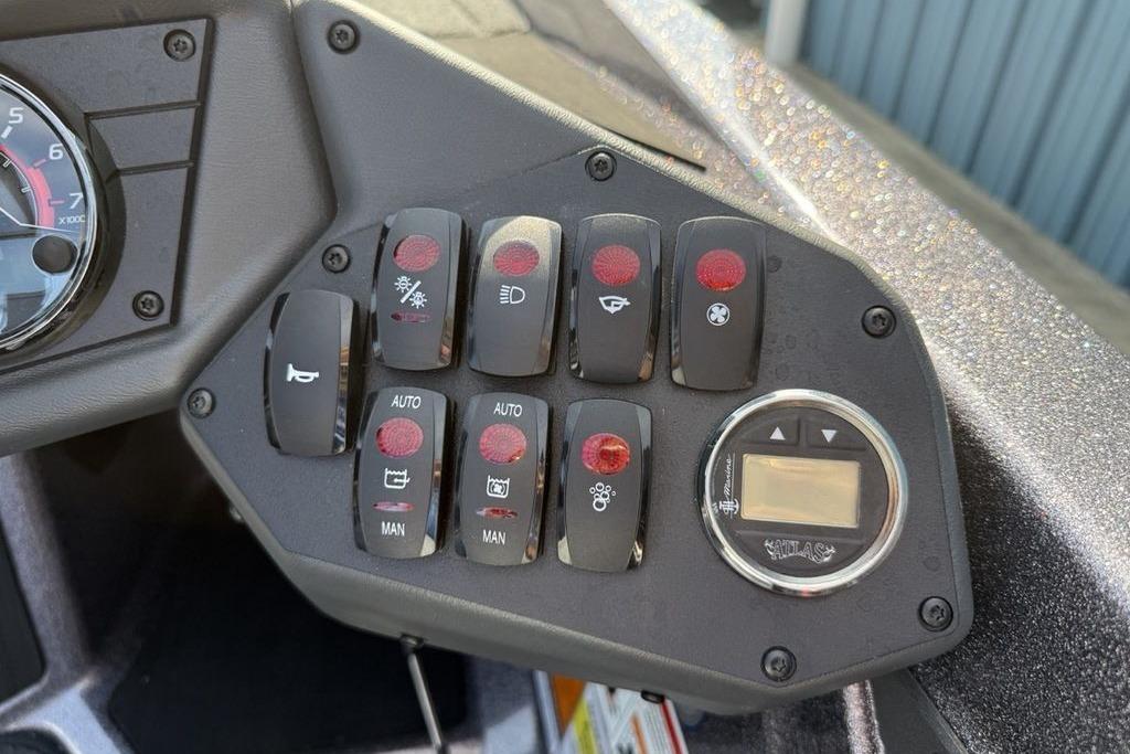 Control panel of a 2026 Skeeter ZXE20 boat with various switches and a digital display.