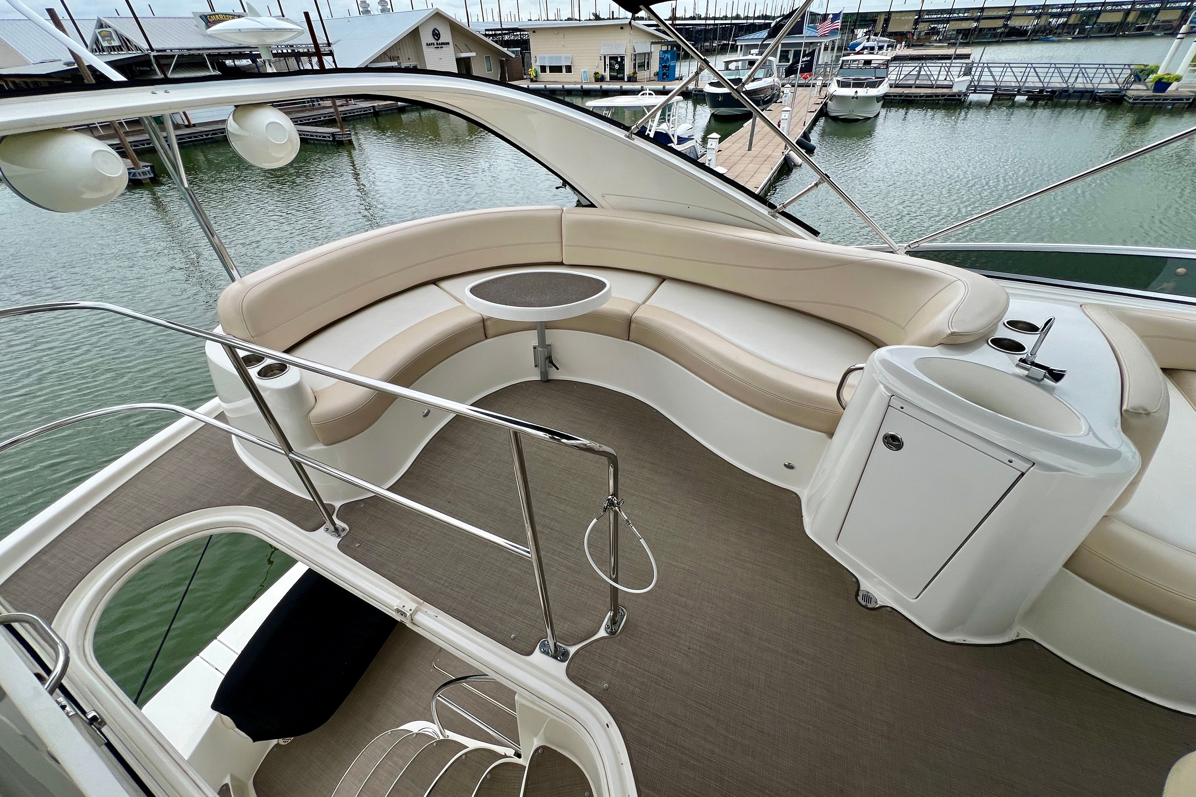 2013 Meridian 391 Sedan yacht with elegant seating area by the water.