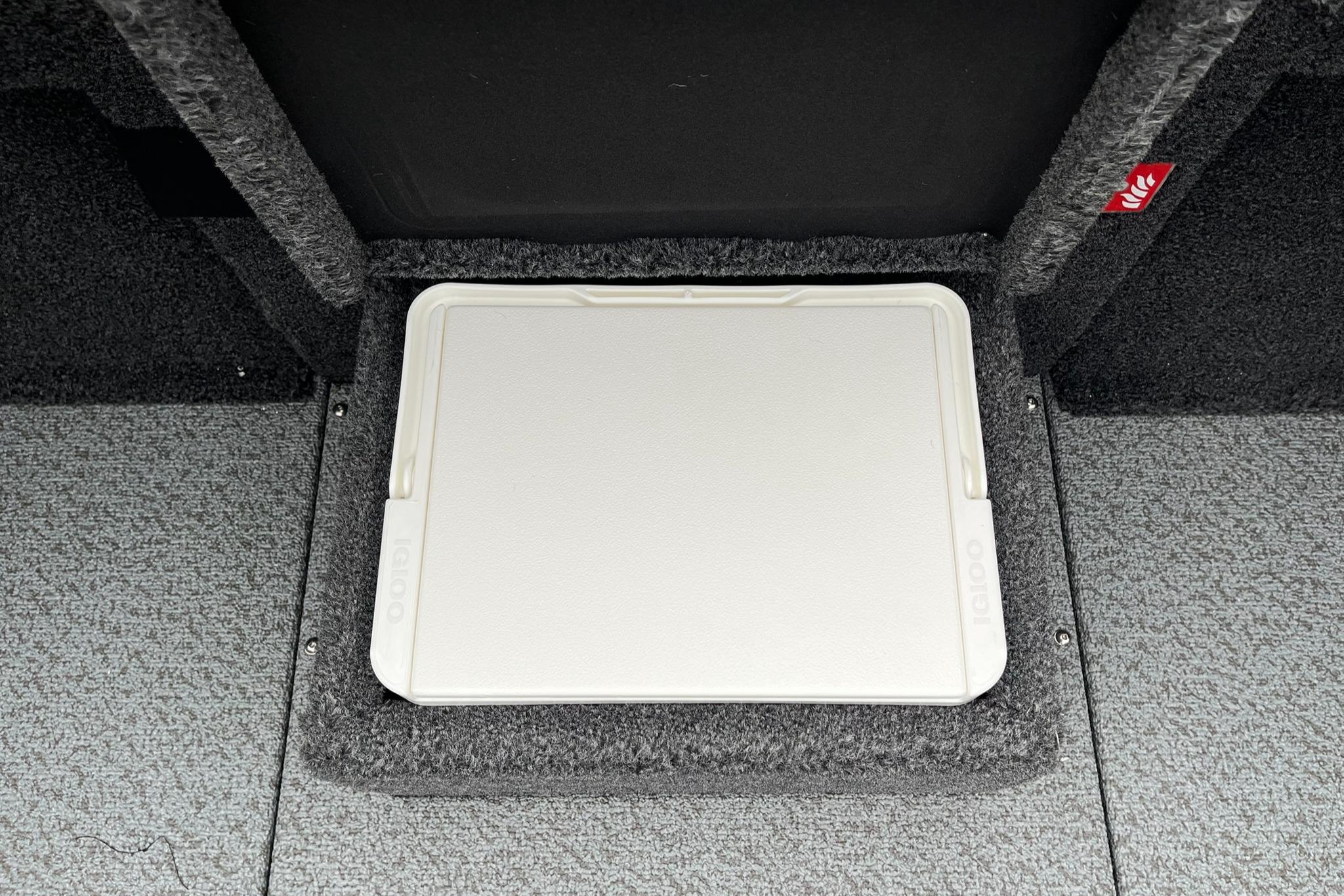 2026 Lund 1875 Pro-V Bass XS boat storage compartment with carpeted interior.