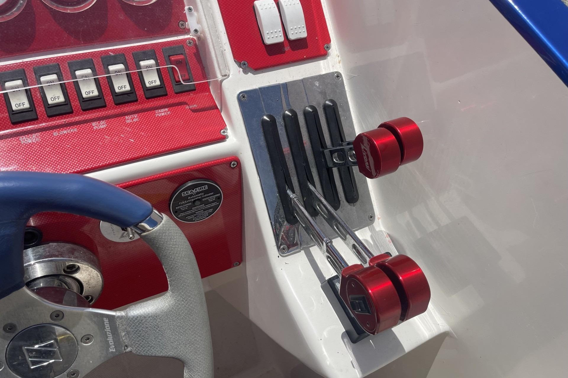 Boat control panel with red throttle levers and switches, Sonic 386, 2006 model.