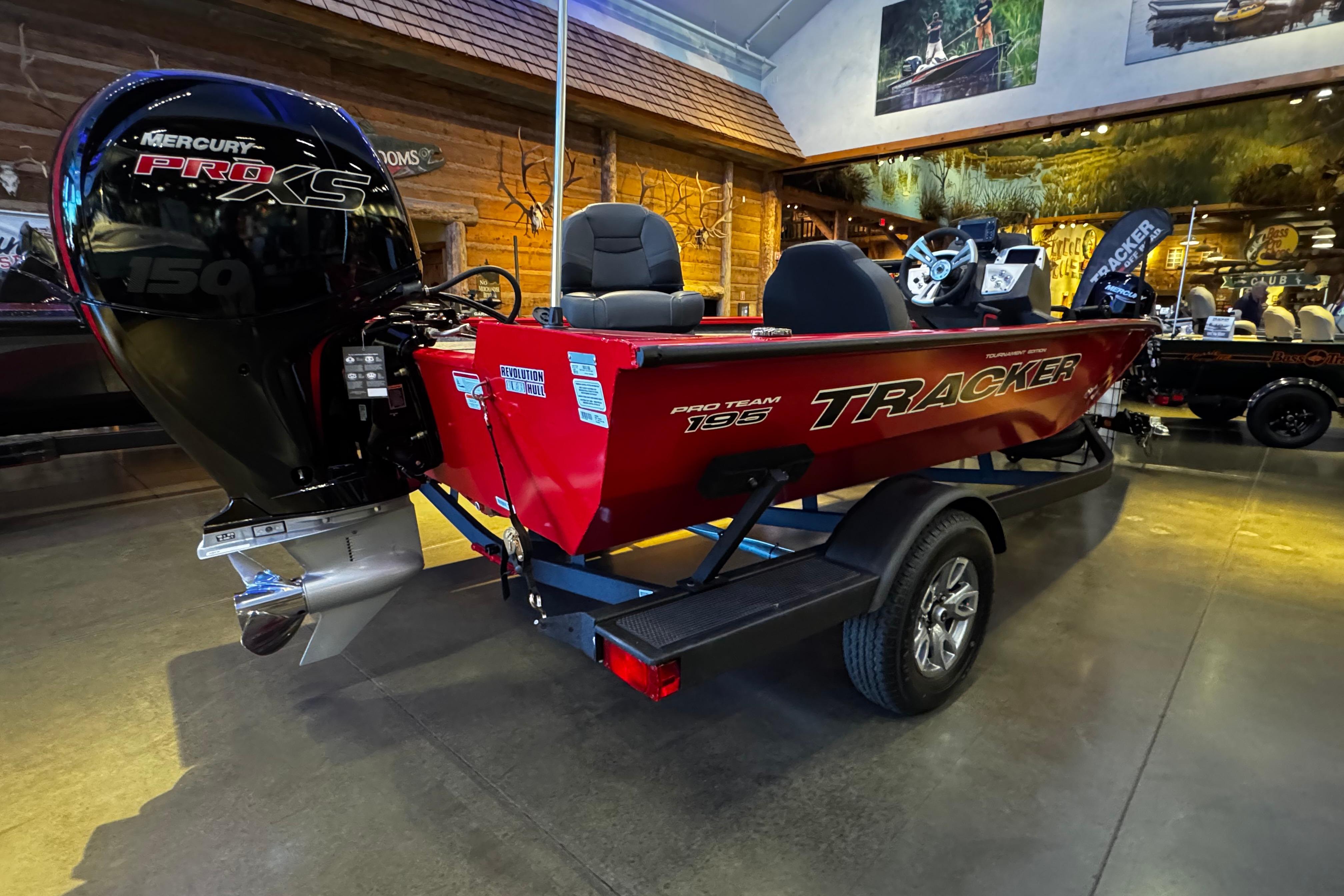 2026 Tracker Pro Team 195 boat with Mercury Pro XS engine in showroom.