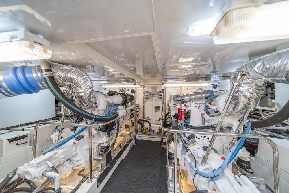Engine room of 2005 Ocean Alexander 64 Motoryacht, featuring dual engines and modern equipment.