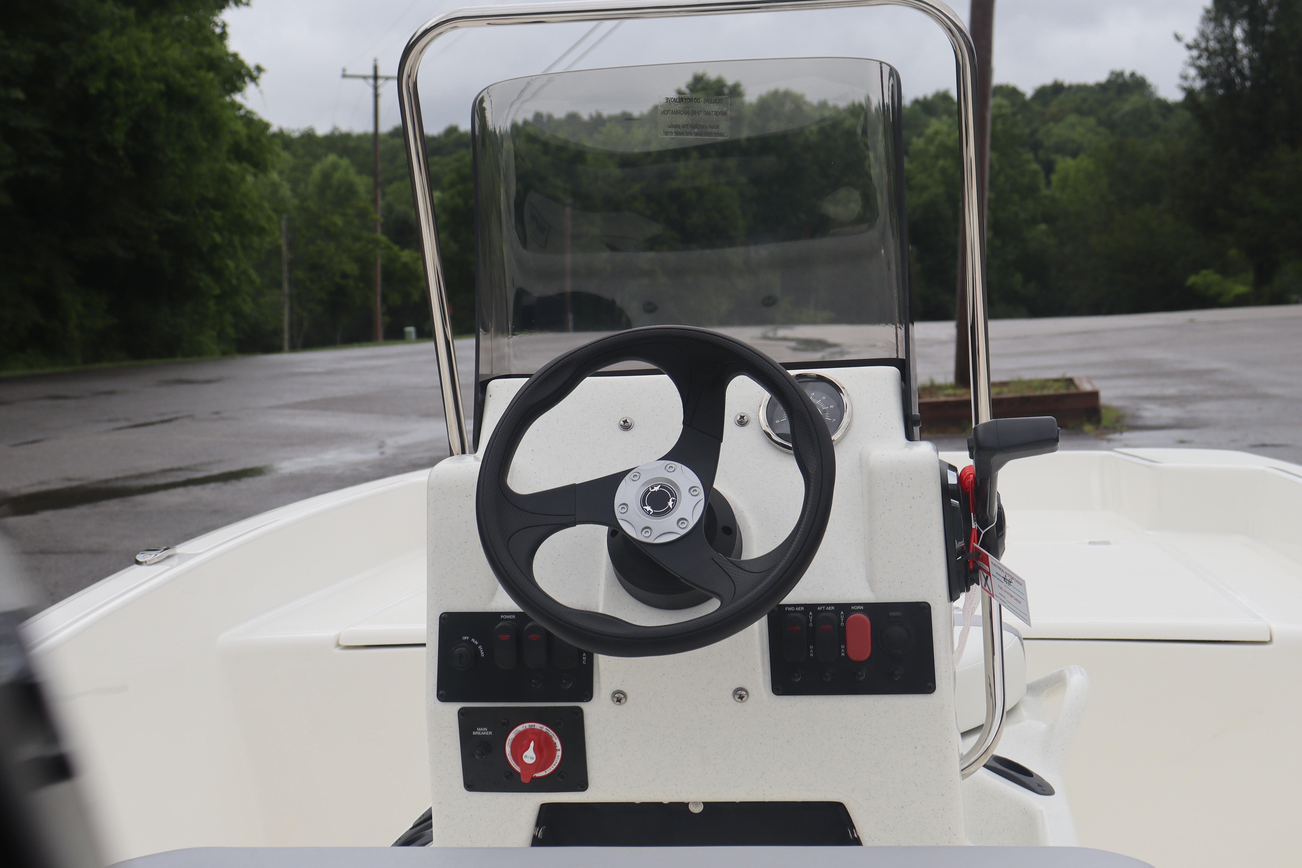 Steering console of 2026 Mako Pro Skiff 17 CC boat, featuring a sleek design.