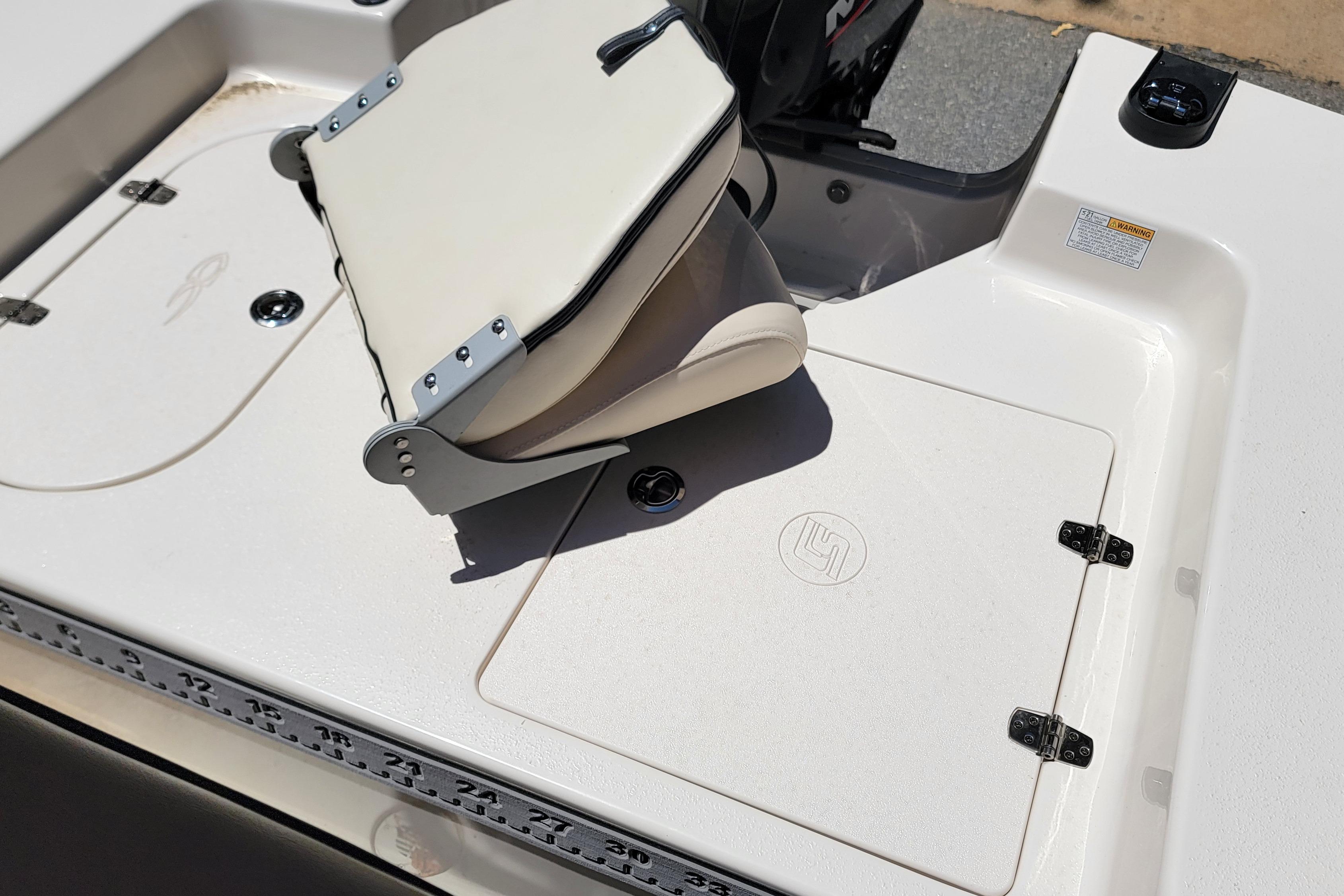 2021 Carolina Skiff 178 JLS boat interior with foldable seat and storage compartments.