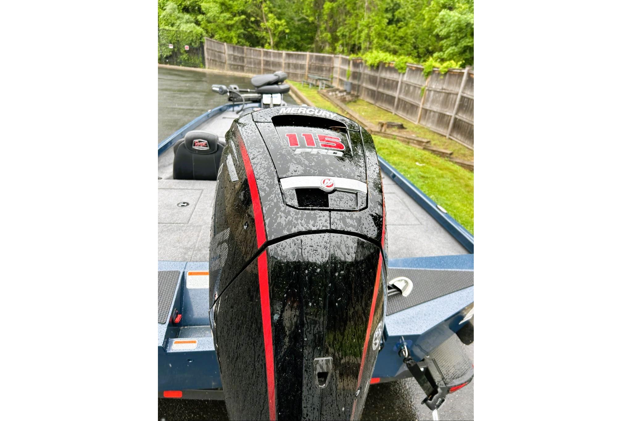 2026 Ranger RT188P boat with Mercury 115 engine, wet from rain, parked outdoors.