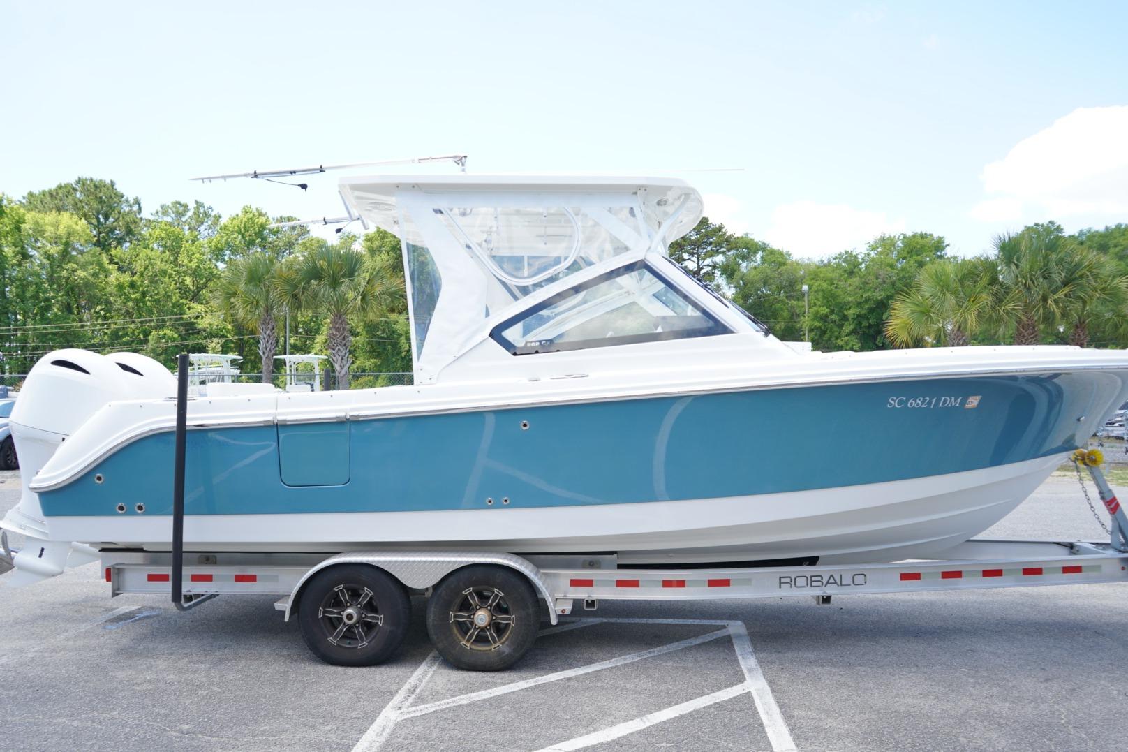 2020 Edgewater 262CX Crossover boat on trailer, parked outdoors.
