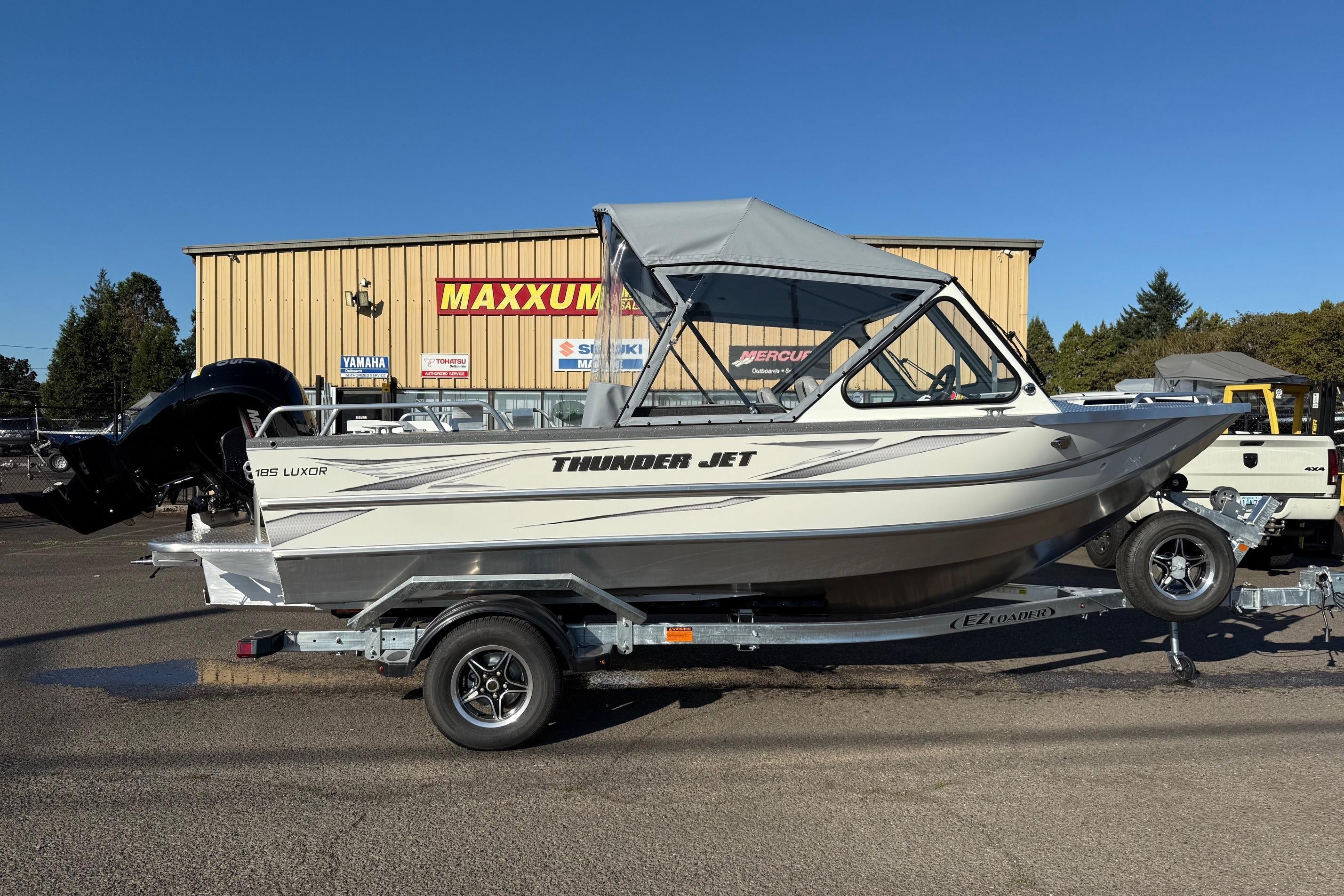 2026 Thunder Jet 185 Luxor boat on trailer, parked outside dealership.