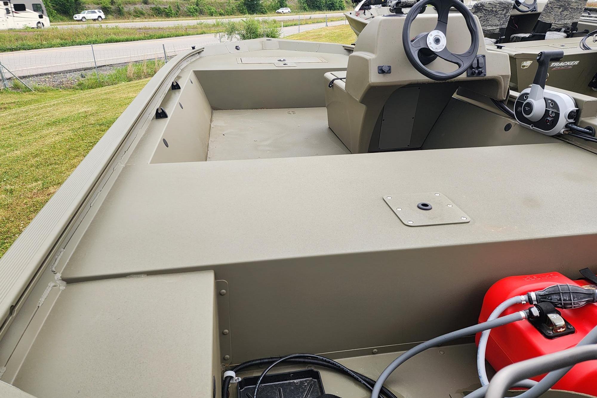 2026 Tracker Grizzly 1648 SC boat interior with steering console and storage compartments.