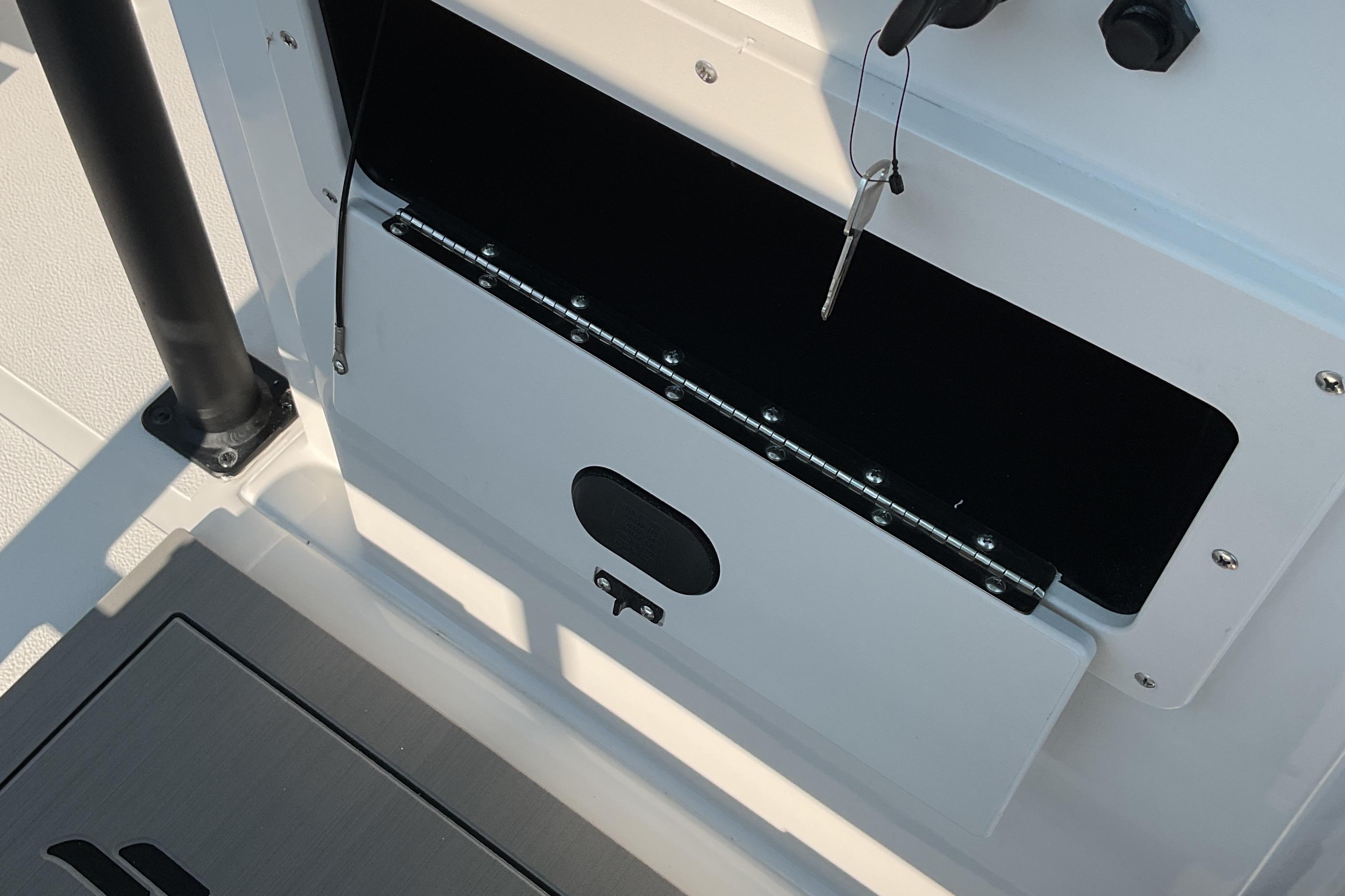 2026 Starcraft SVX 231 OB CC boat storage compartment with open hatch and secure latch.