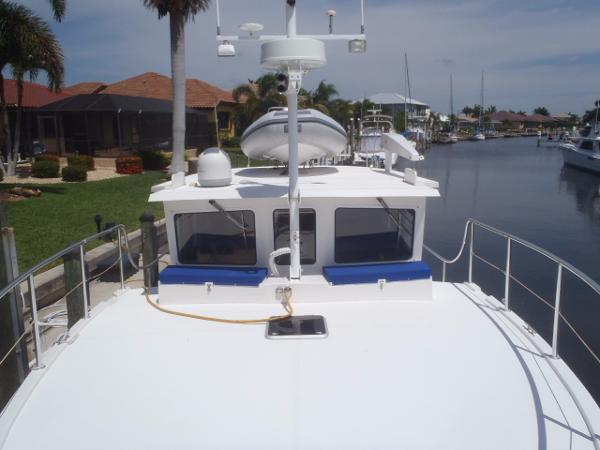 Great Harbour N40 yacht docked in a canal, featuring a spacious deck and modern design, 2025 model.