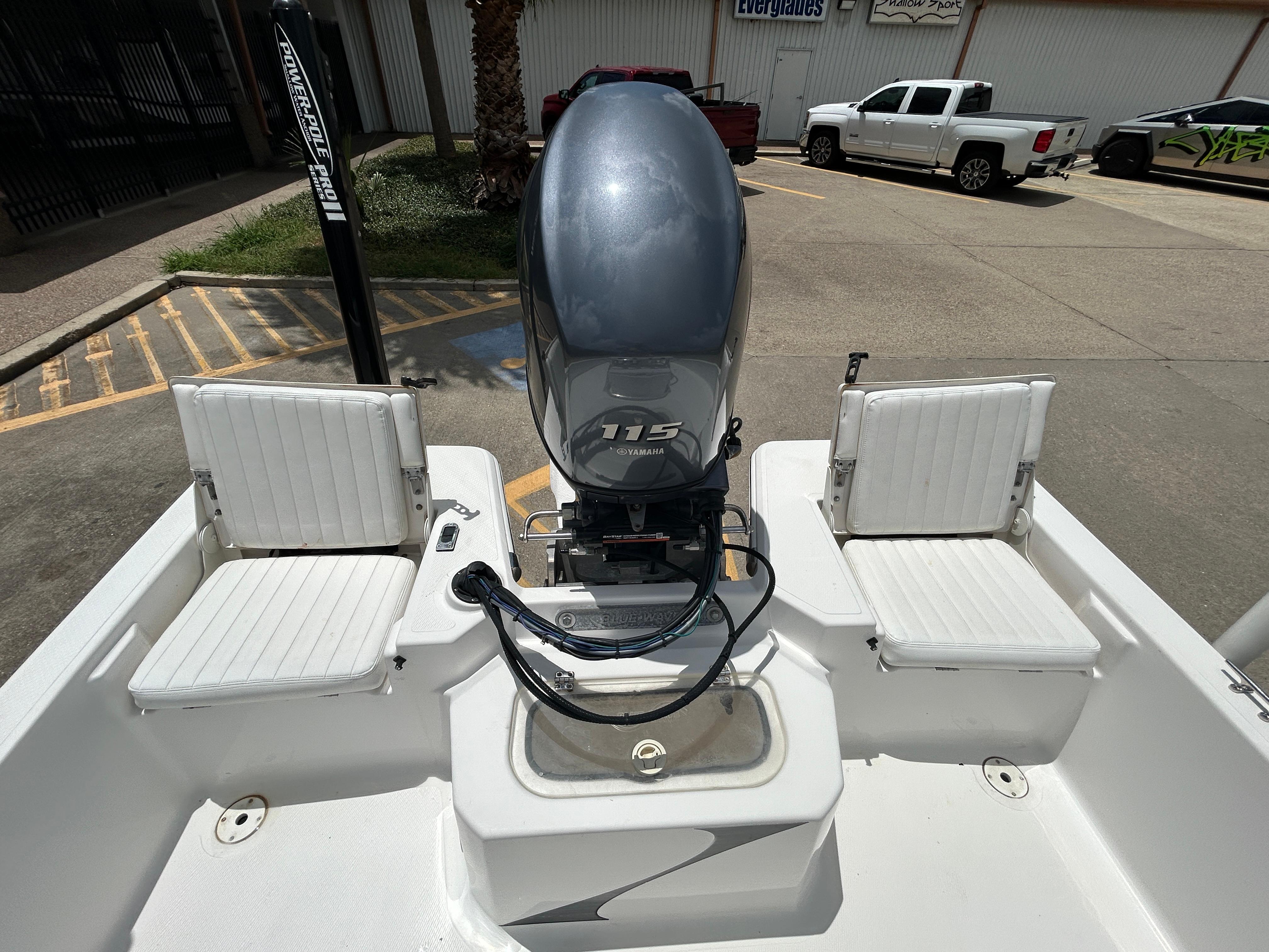2012 Blue Wave 1900 STL boat with Yamaha 115 engine, parked outdoors.