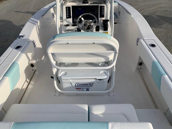 2024 Robalo R202 Explorer boat interior with helm, seating, and Coleman cooler.