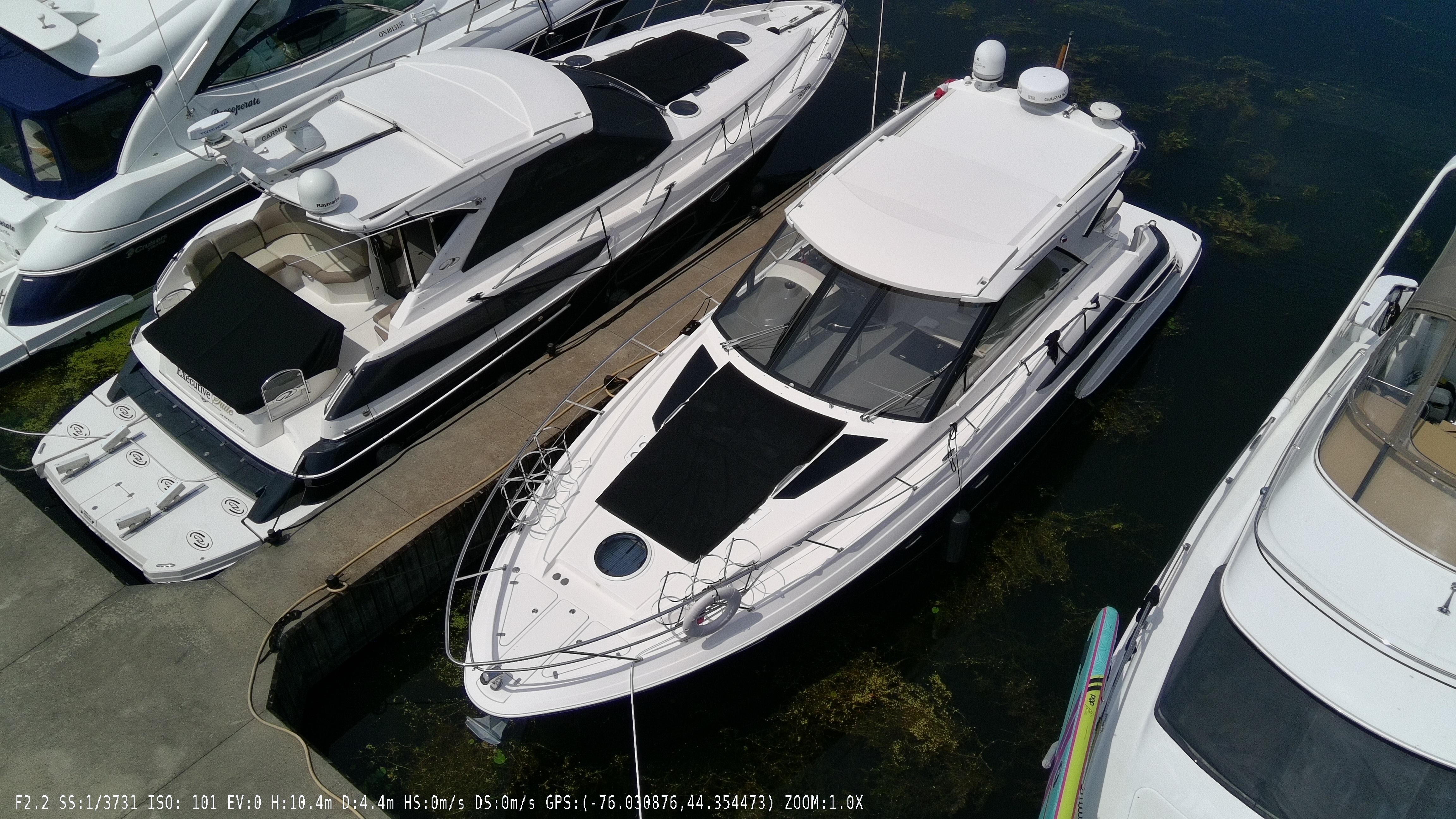 2011 Regal 42 Sport Coupe docked among other boats in a marina.