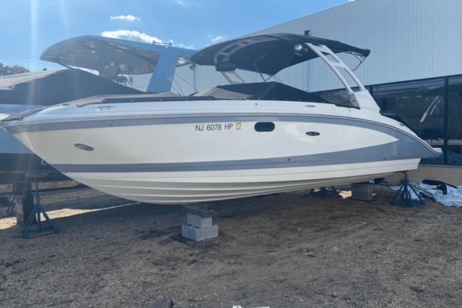 2021 Sea Ray SDX 270 boat on display, white and gray, with canopy, outdoors.