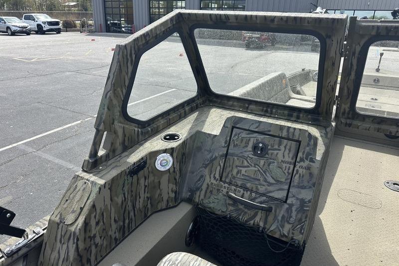 2026 SeaArk EasyCat boat interior with camouflage design and windshield in a parking lot.