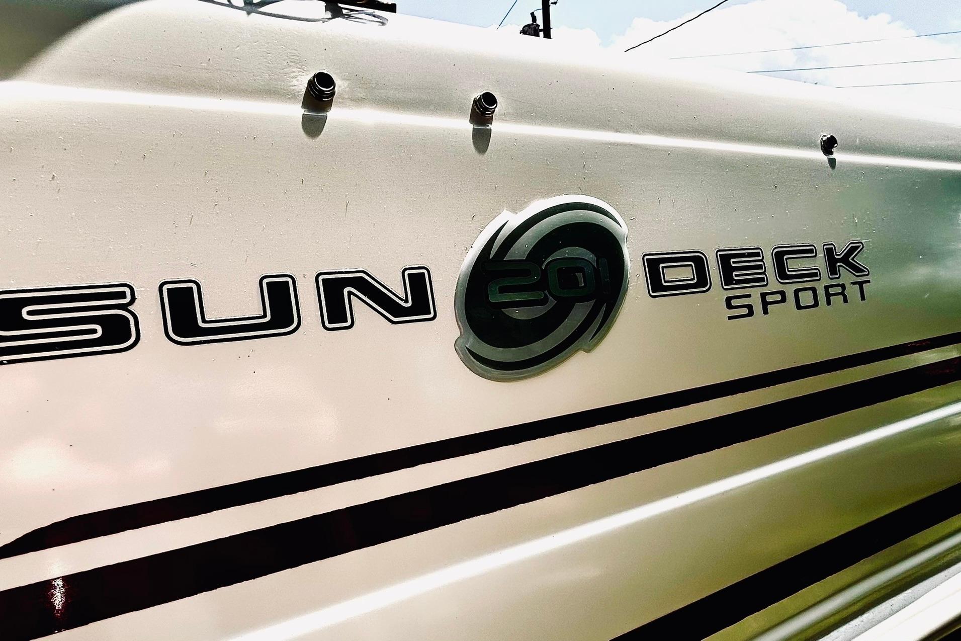 2013 Hurricane SunDeck Sport 201 OB boat logo on a sleek white hull.