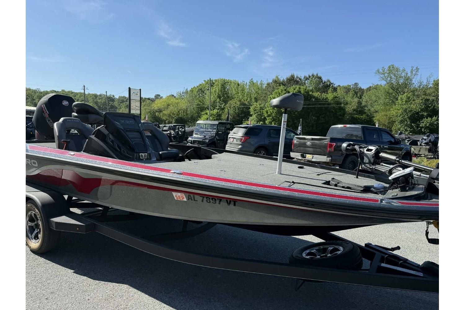 2023 Nitro Z20 Pro bass boat on trailer in parking lot.