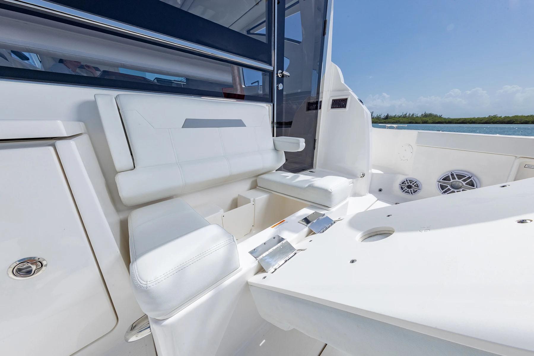 Manufacturer Provided Image: 2025 Pursuit OS 445 Offshore boat interior with white seating and ocean view.