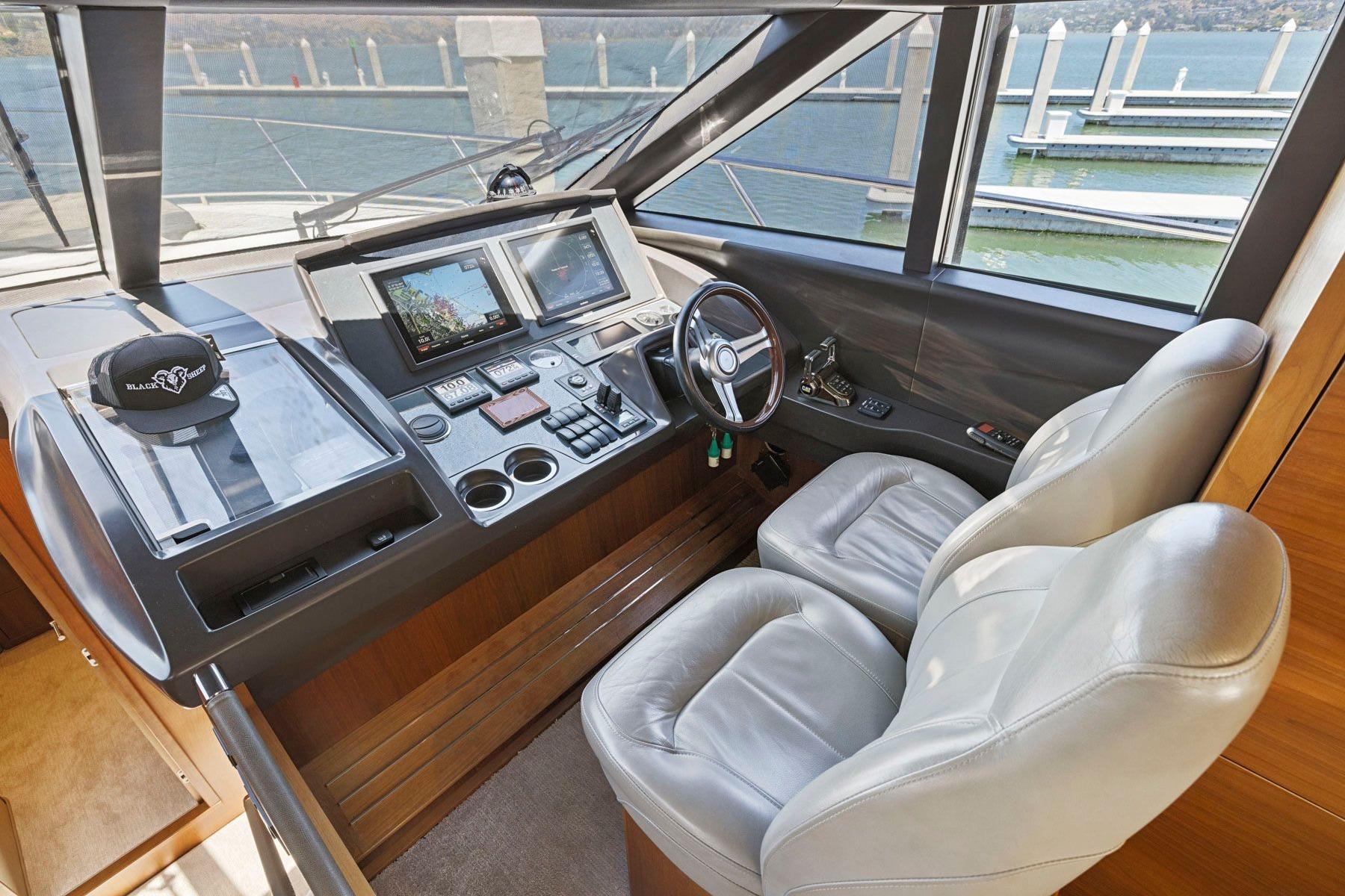 Helm of 2015 Princess 60 Flybridge Motor Yacht with dual seats and navigation controls.