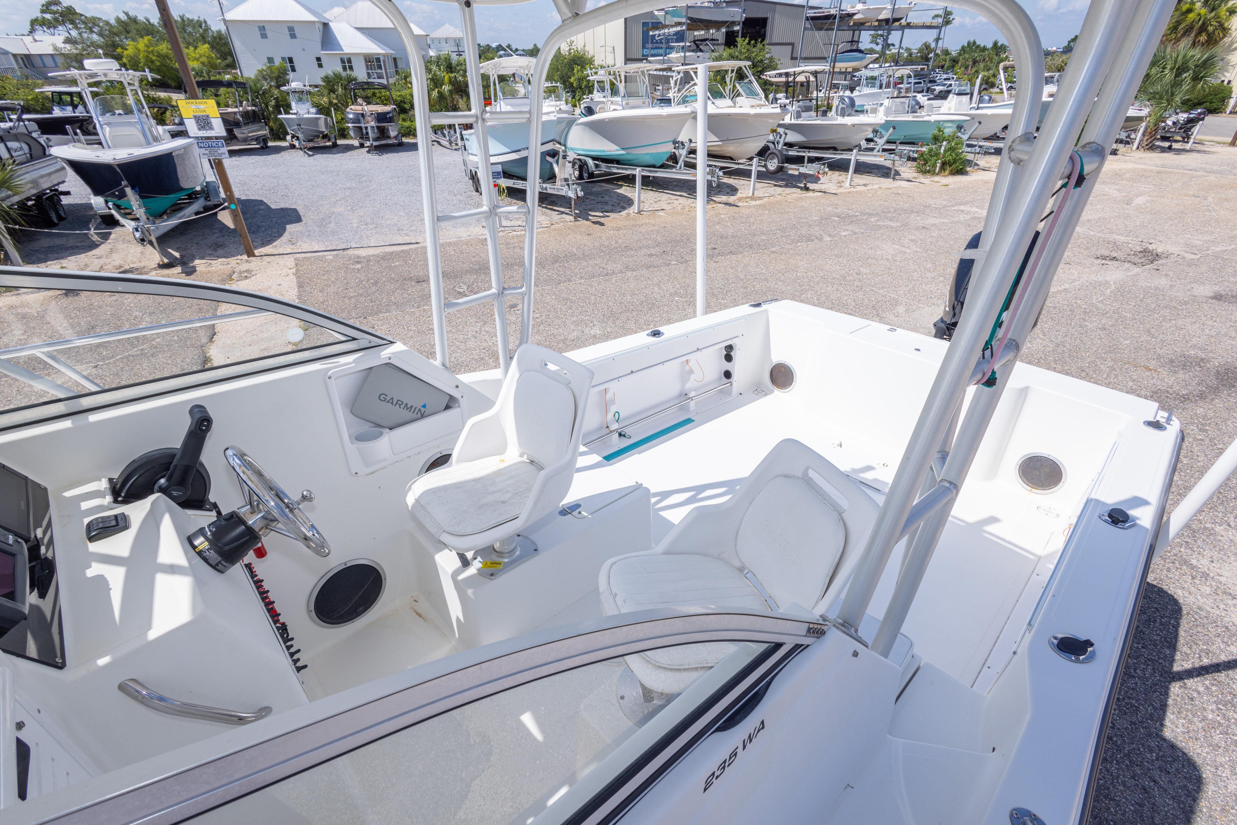 2007 Sea Boss 235 Walkaround boat interior with helm, seating, and Garmin equipment.