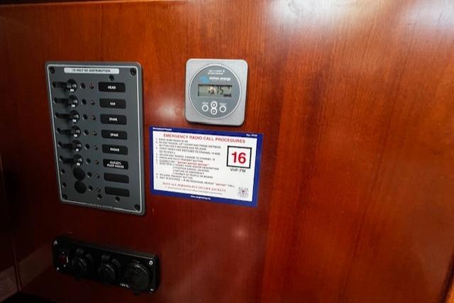 Control panel on 2006 Beneteau 343 Sloop with emergency radio call procedures.