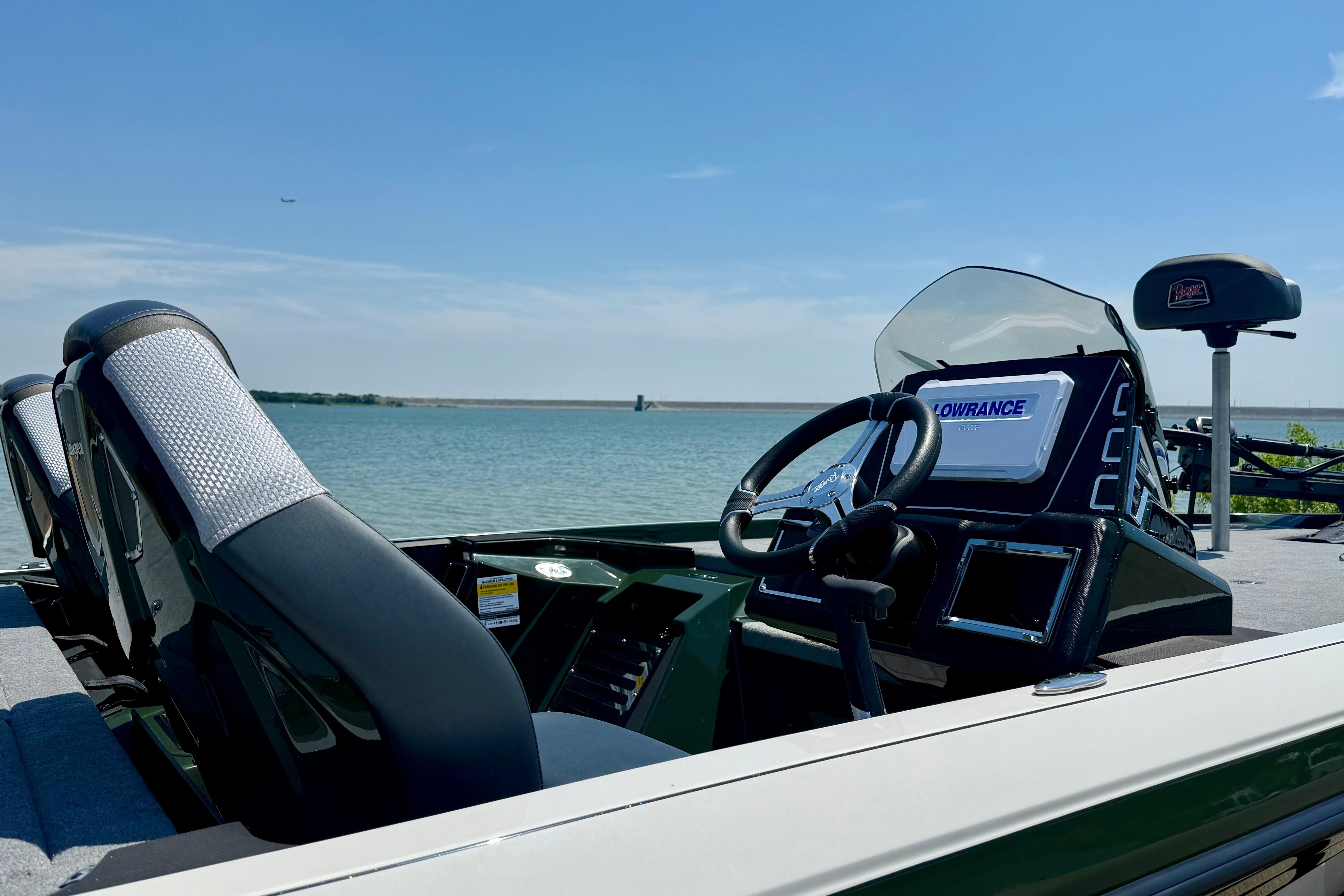 2026 Ranger Z519R boat interior with steering wheel and navigation system, overlooking a serene lake.