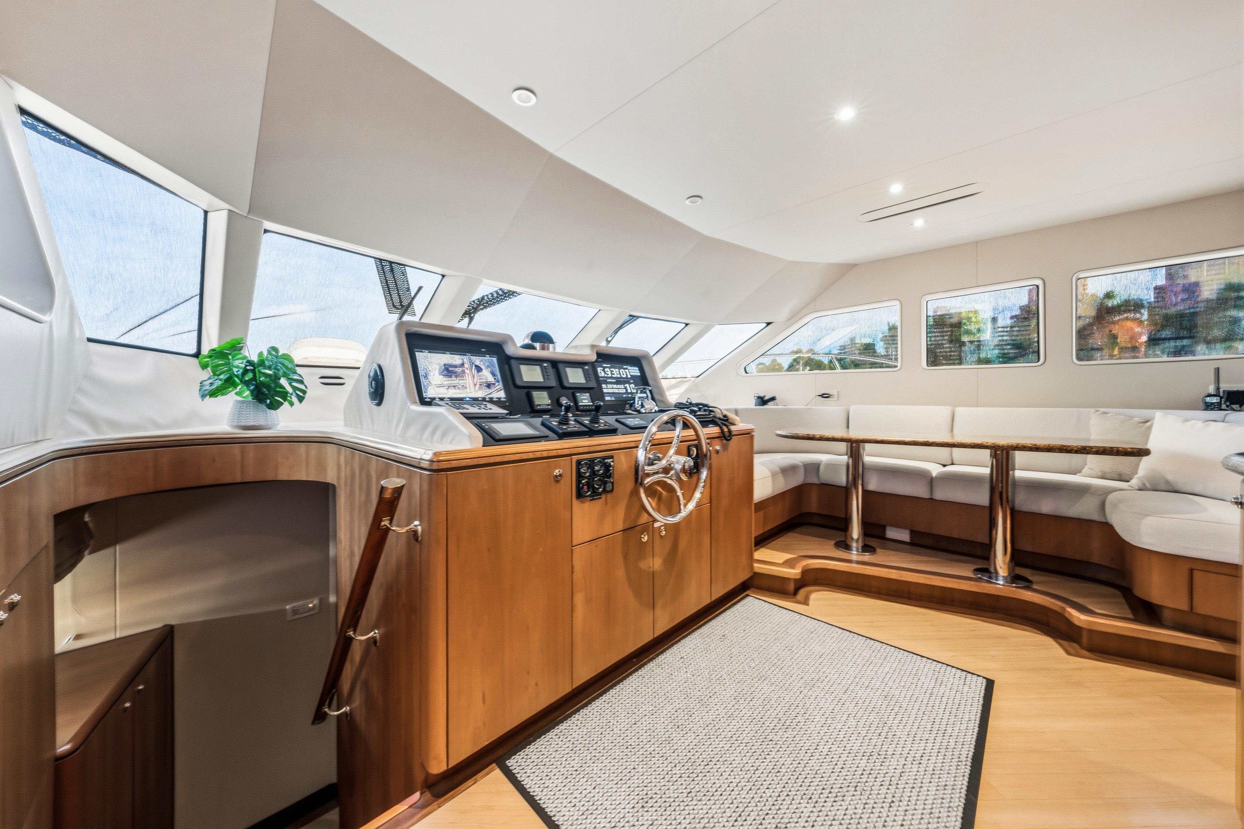 Luxurious interior of 2006 Cheoy Lee 84 Bravo yacht with helm and seating area.
