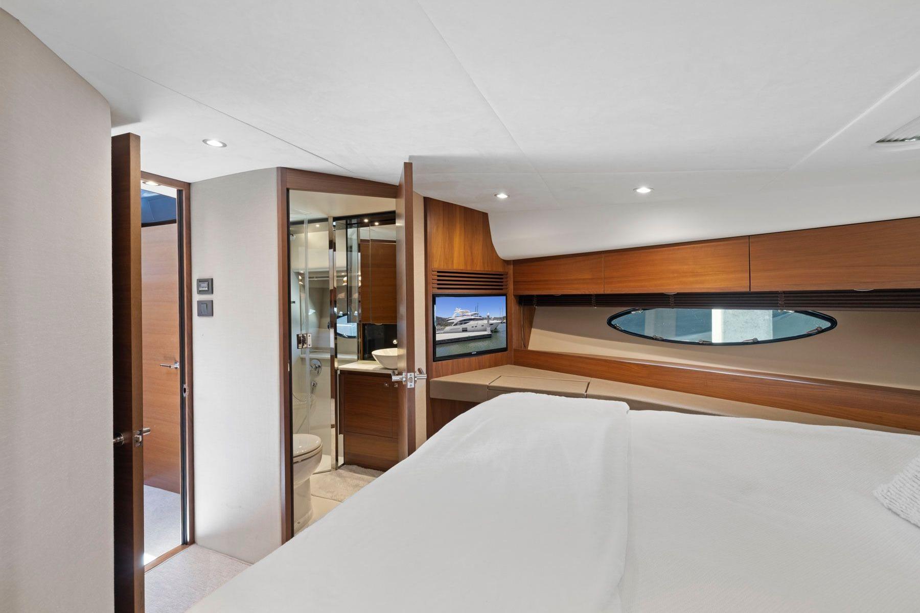 Luxurious bedroom interior of 2015 Princess 60 Flybridge Motor Yacht with ensuite bathroom.