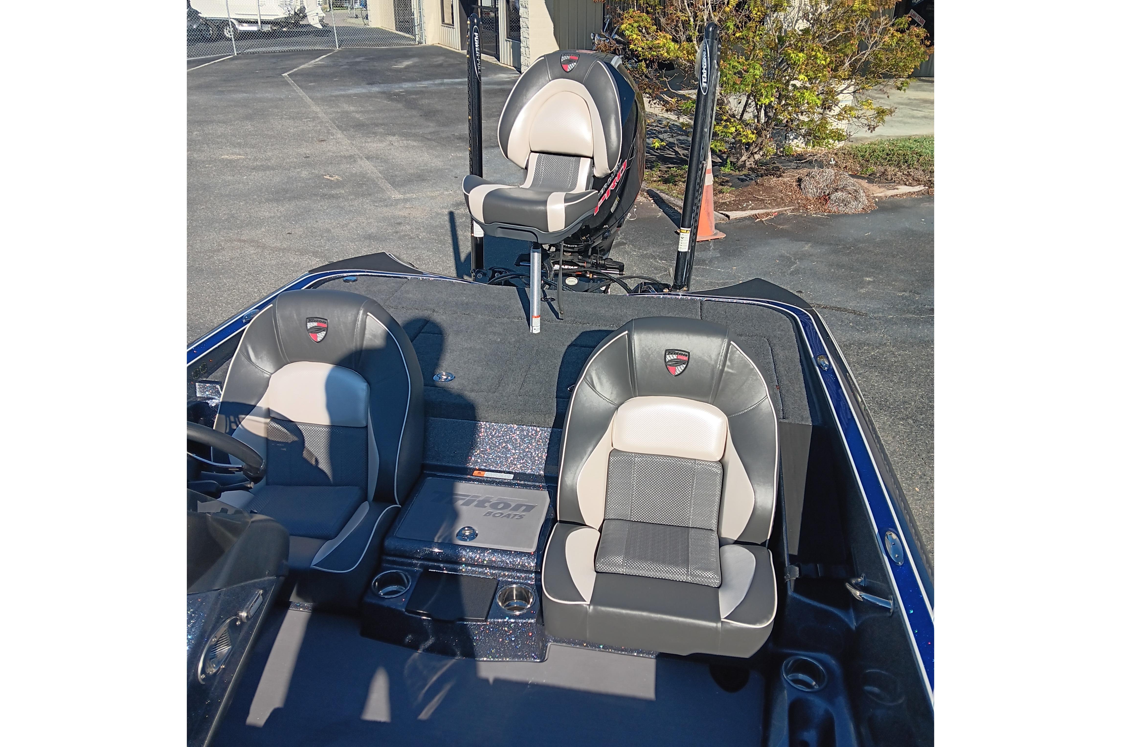 2026 Triton 18 TrX boat interior with three cushioned seats, parked outdoors.